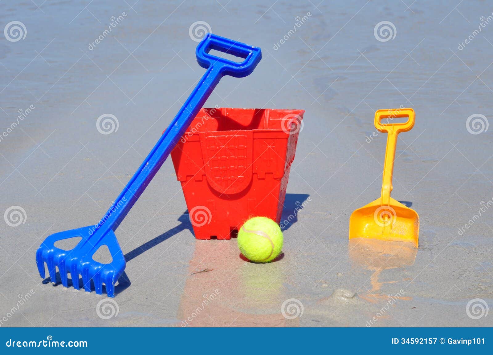 Red Bucket Spade Ball And Rake On The Beach In A G Stock Image Image of tools, ocean 34592157