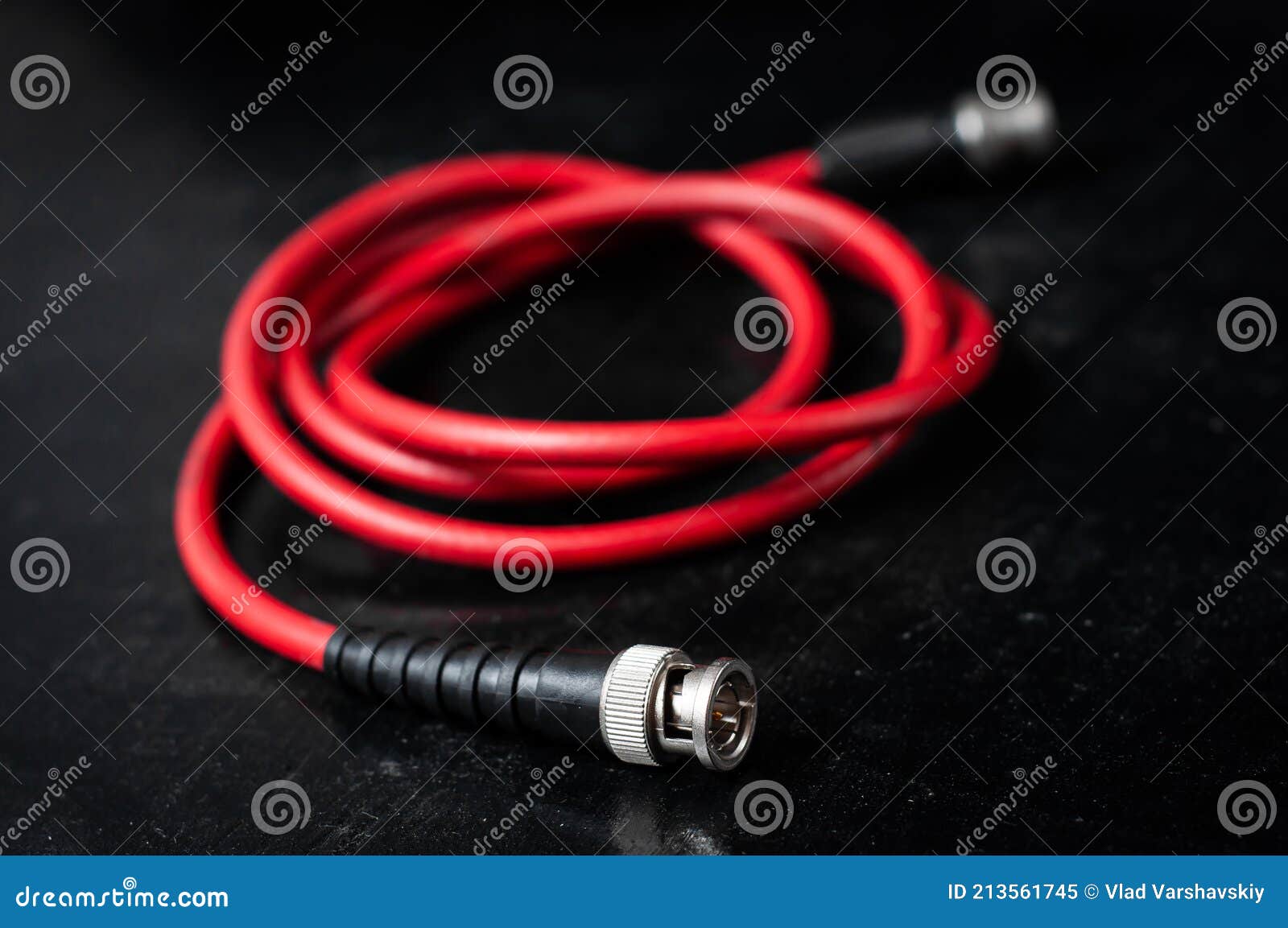 red cable for transferring sdi signal through bnc connector on a dark background