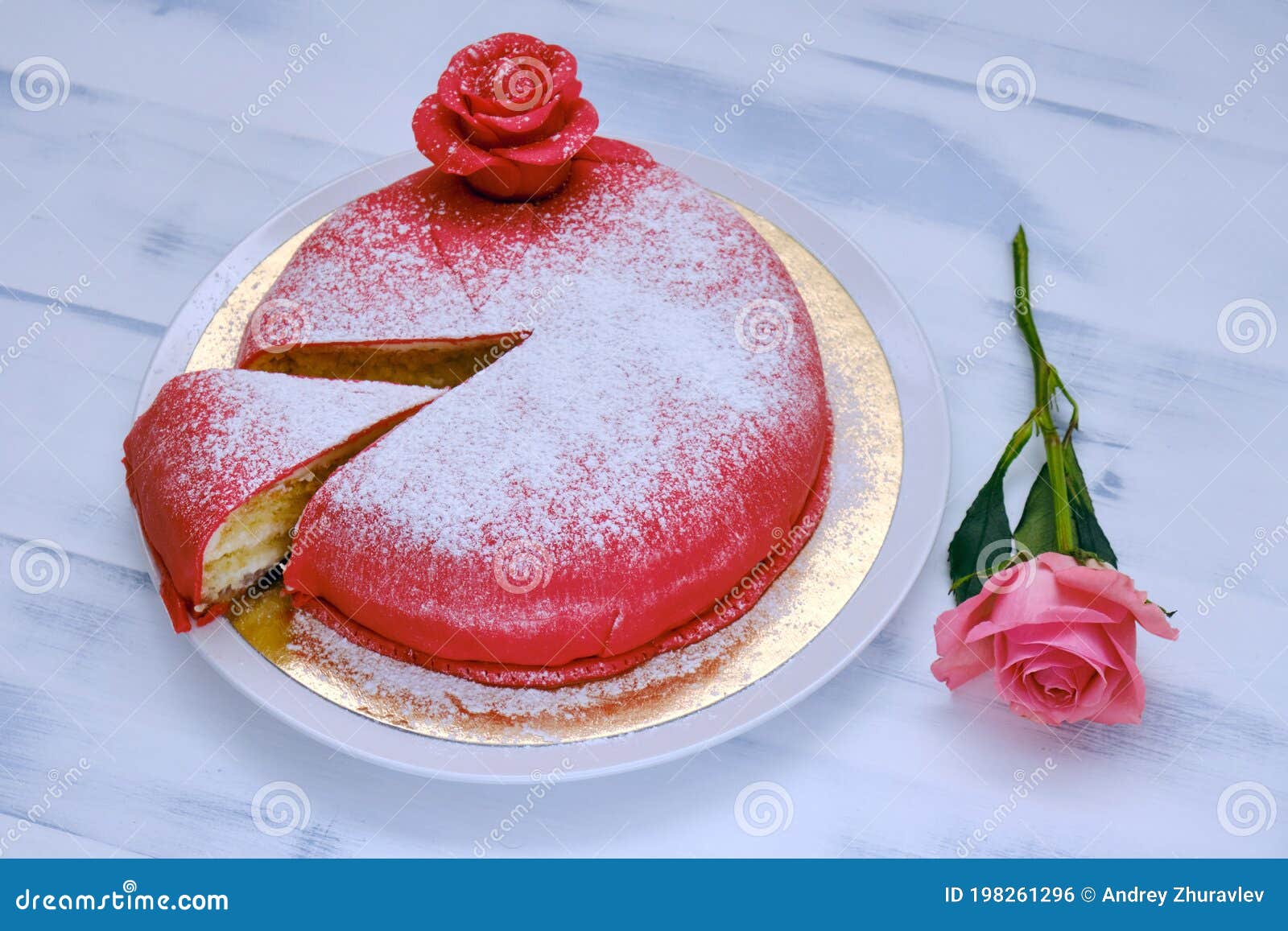 Red Cake Covered with Marzipan or Mastic with a Cut Piece and Sprinkled