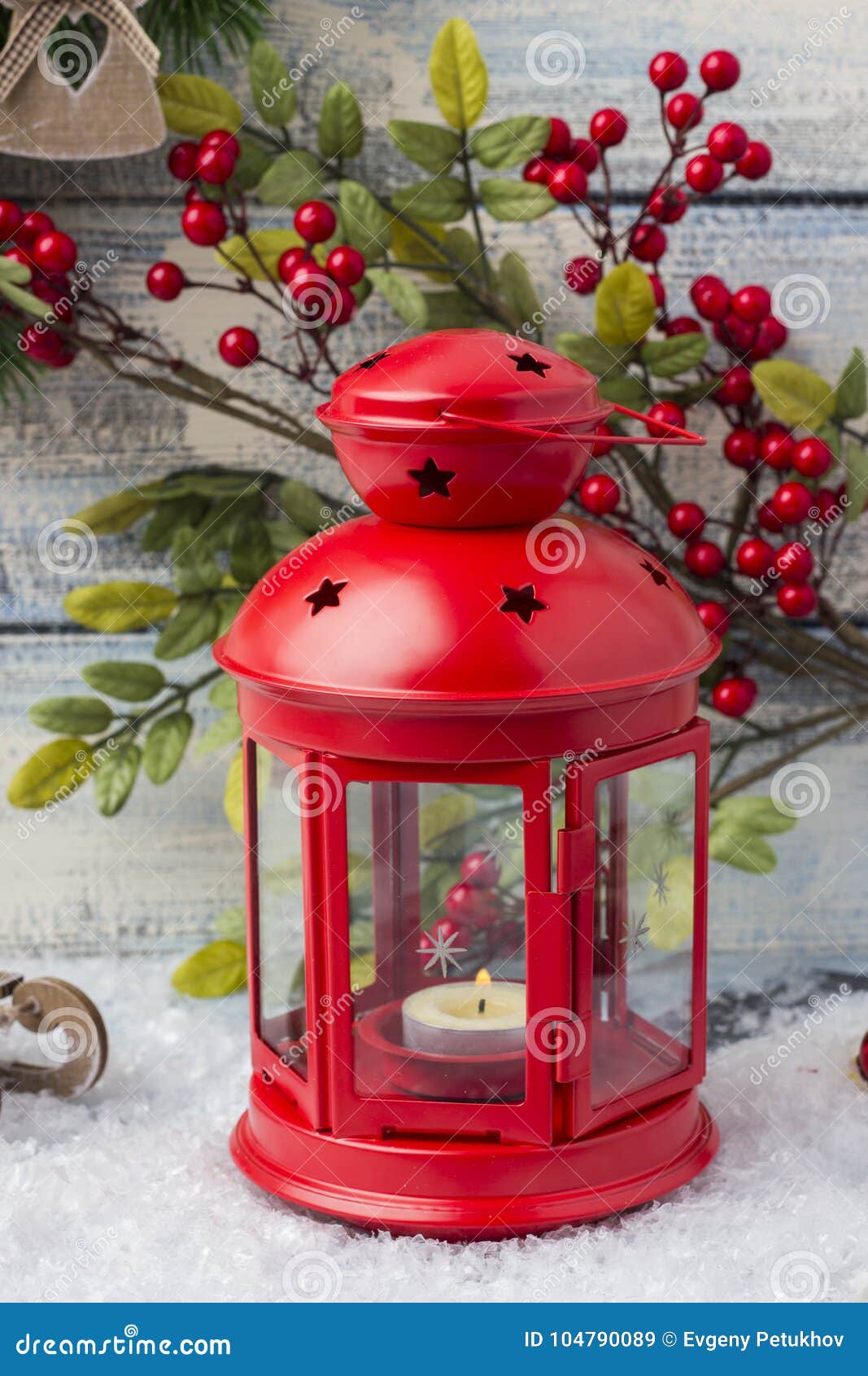 Red Candlestick with a Candle Inside and a Branch of a Christmas Tree