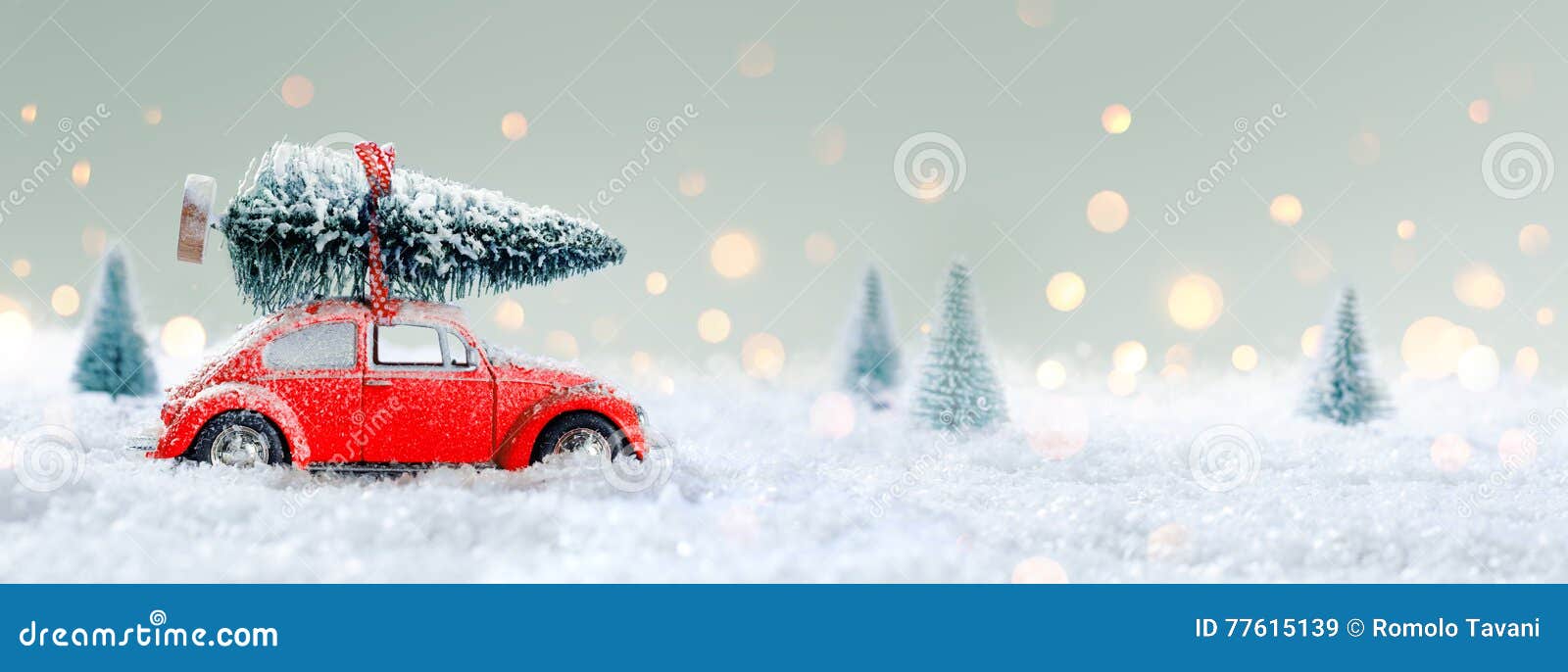 red car carrying a christmas tree