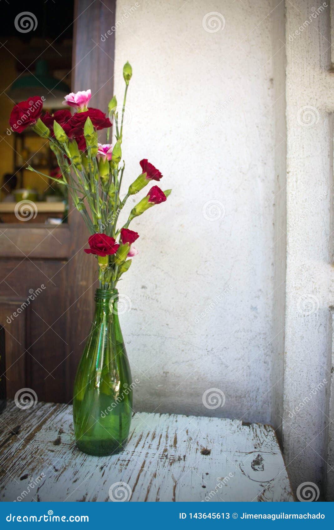 Red Carnations in a Green Bottle Stock Image Image of bottle, gift