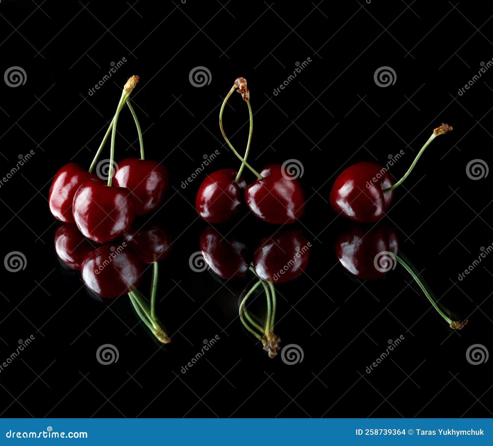 Red Cherries on a Black Background with Reflection. Fresh Cherries on a