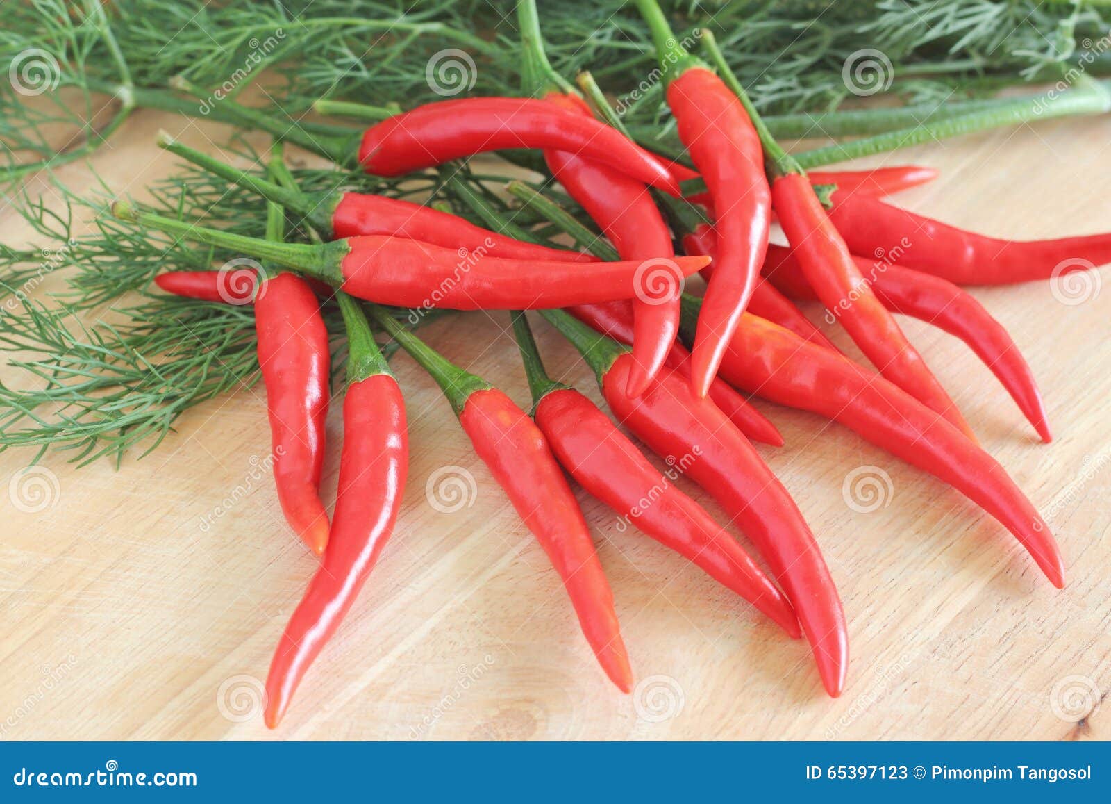 Red chilli pepper or paprika on wooden background