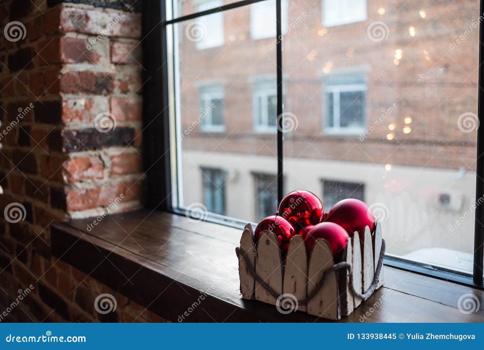 Red Christmas Balls In A Box On A Wooden Window Sill Stock