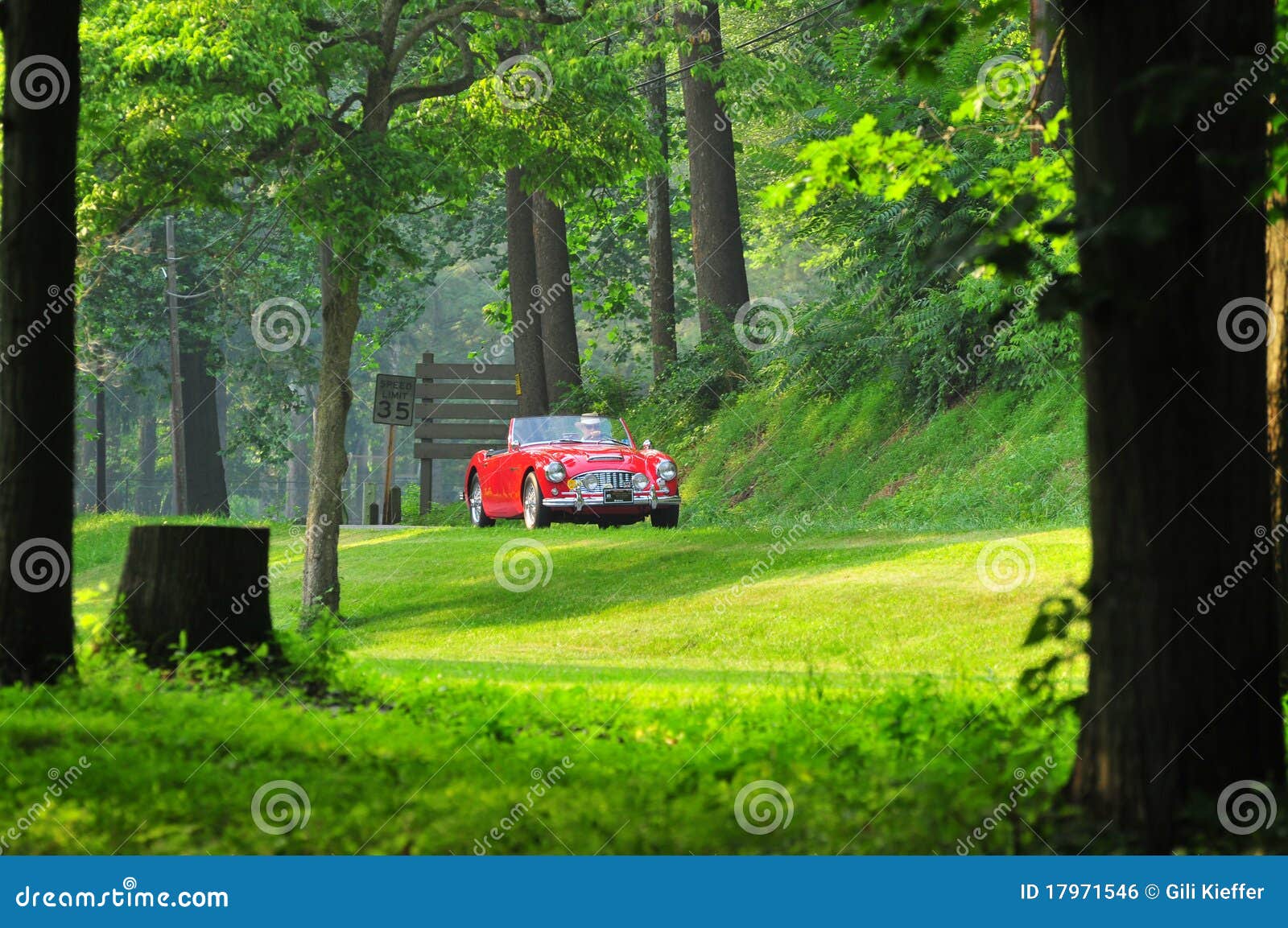 red classic car on the road