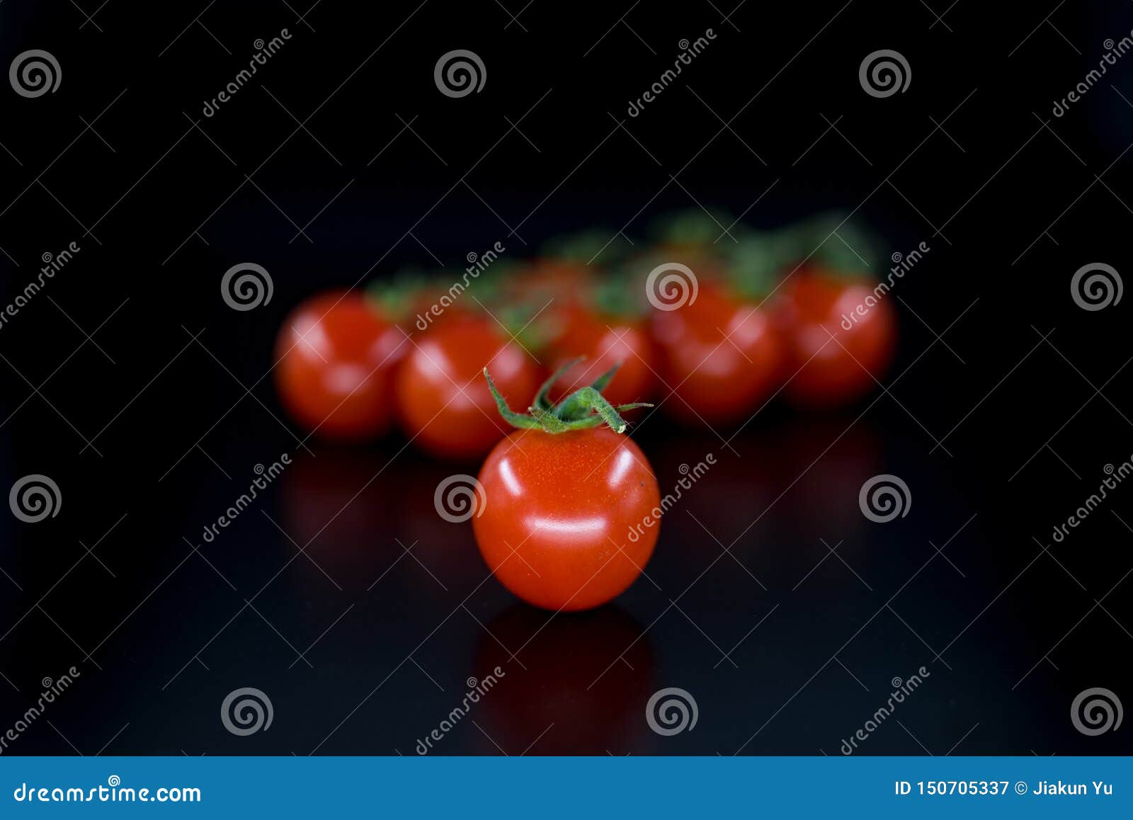 red cluster tomato  on black background.
