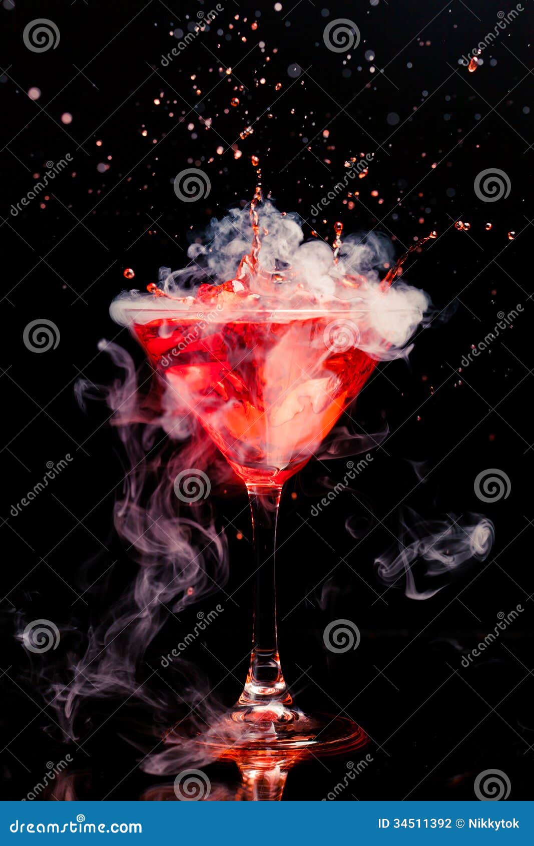 red cocktail with splash and ice vapor