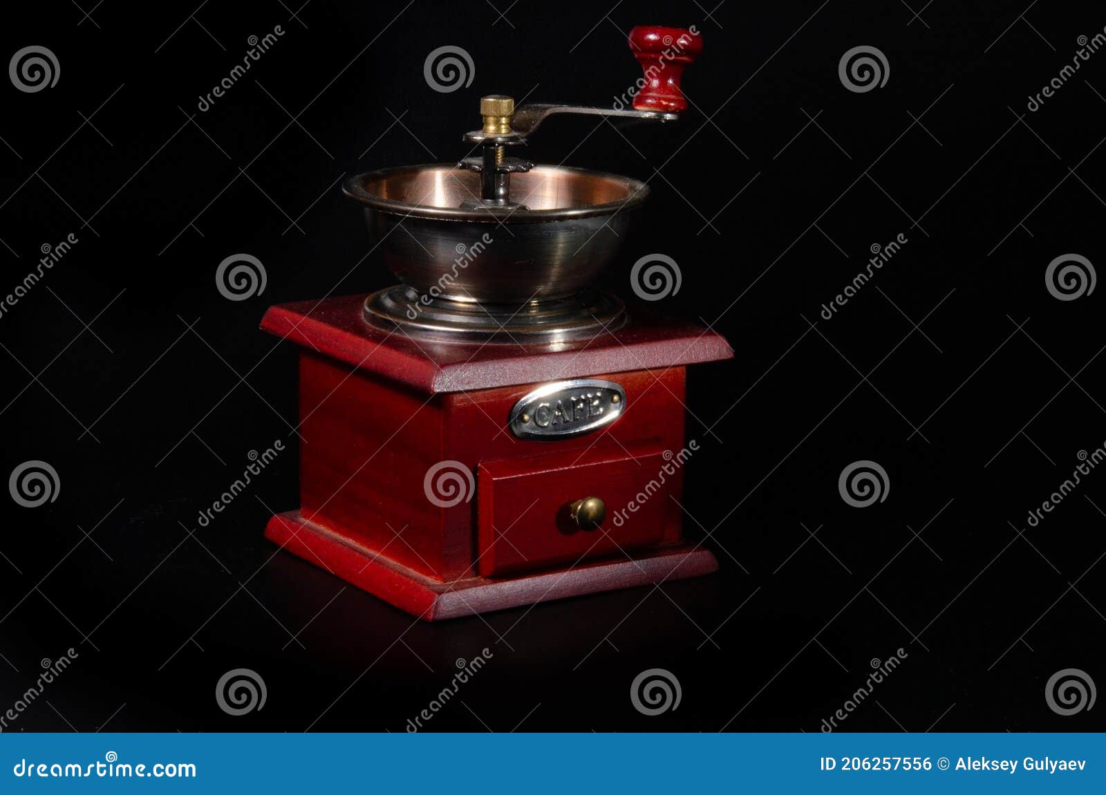 Red Coffee Grinder in Vintage Style on a Black Background Stock Photo