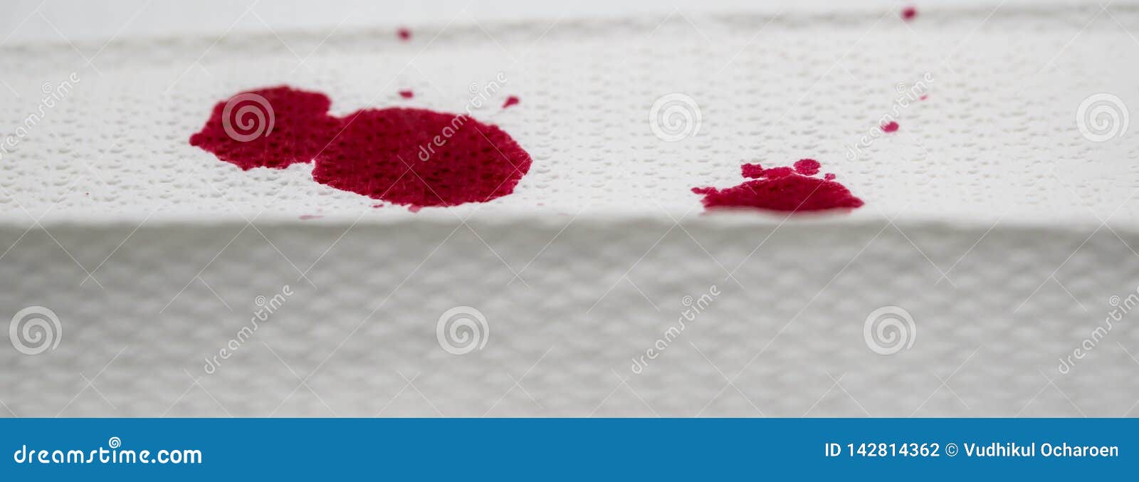 red color drops on textured towel paper, like nosebleed. closed up image for crime scene
