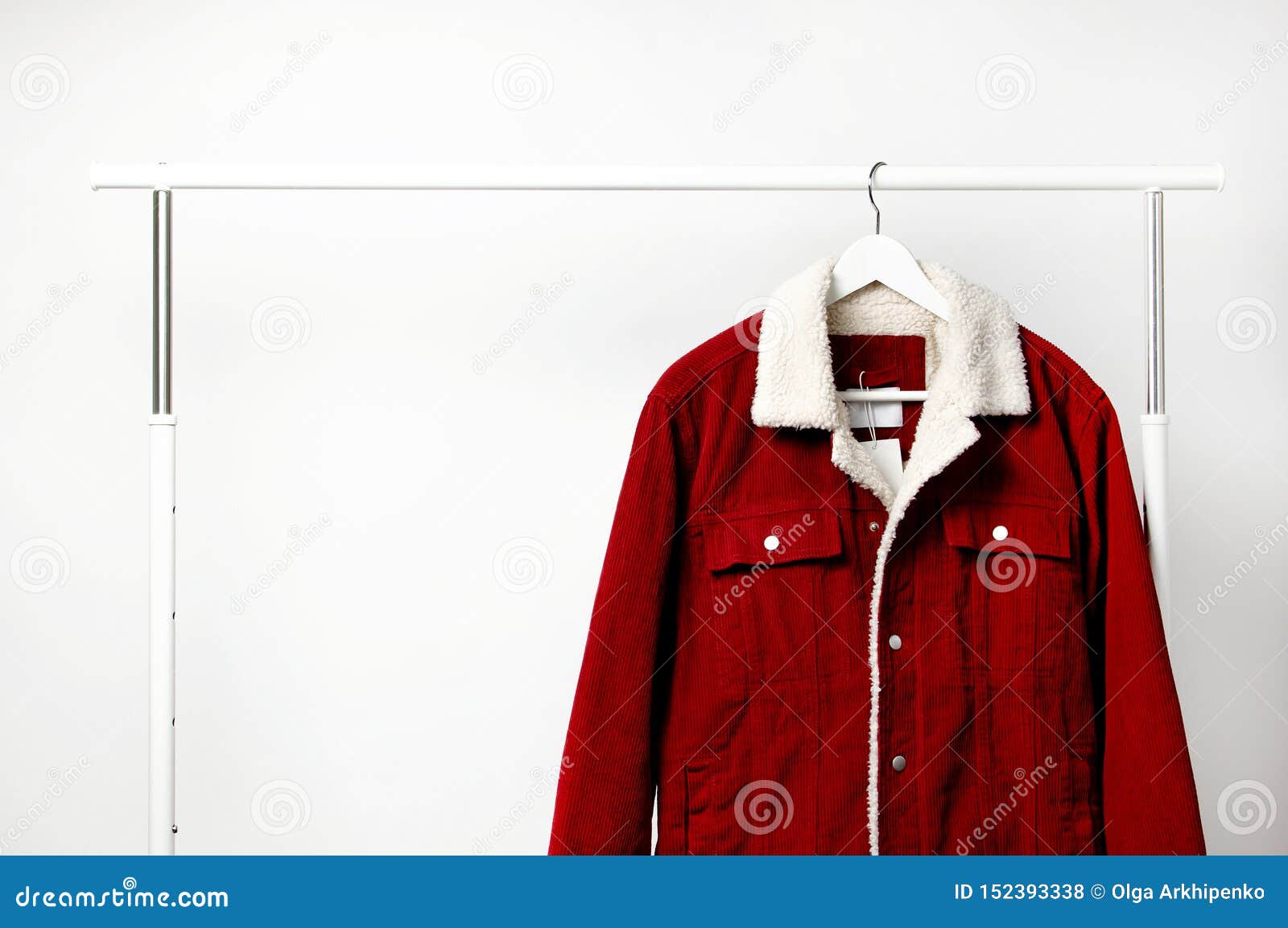 Red Corduroy Men`s Jacket on White Coat Hanger on Rod Against Light ...