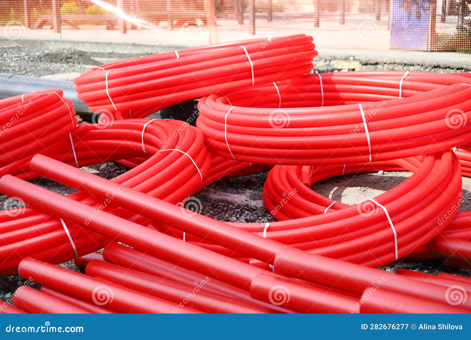 Red Corrugated Pipe for Wire at Construction Site. Cable Conduit for