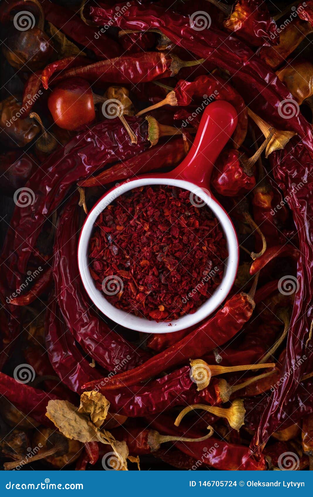 Red Cup with Ground Red Pepper Surrounded by Dry Pods of Red Pepper