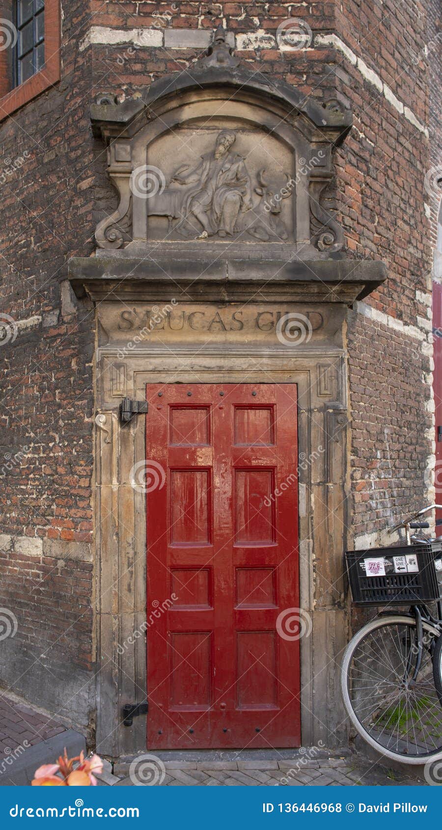 red door and gable stone for s. lucas gild, waag house, amsterdam, the netherlands