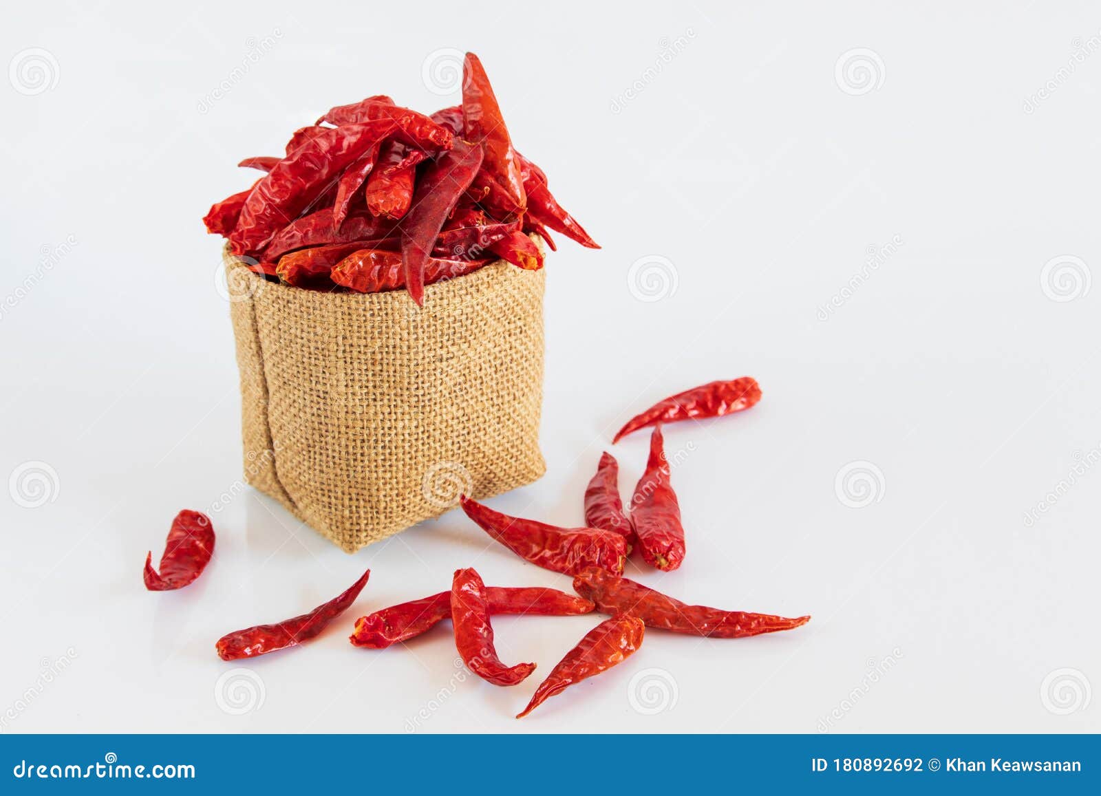 Red Dried Chili Pepper in Brown Bag on White Background Stock Photo