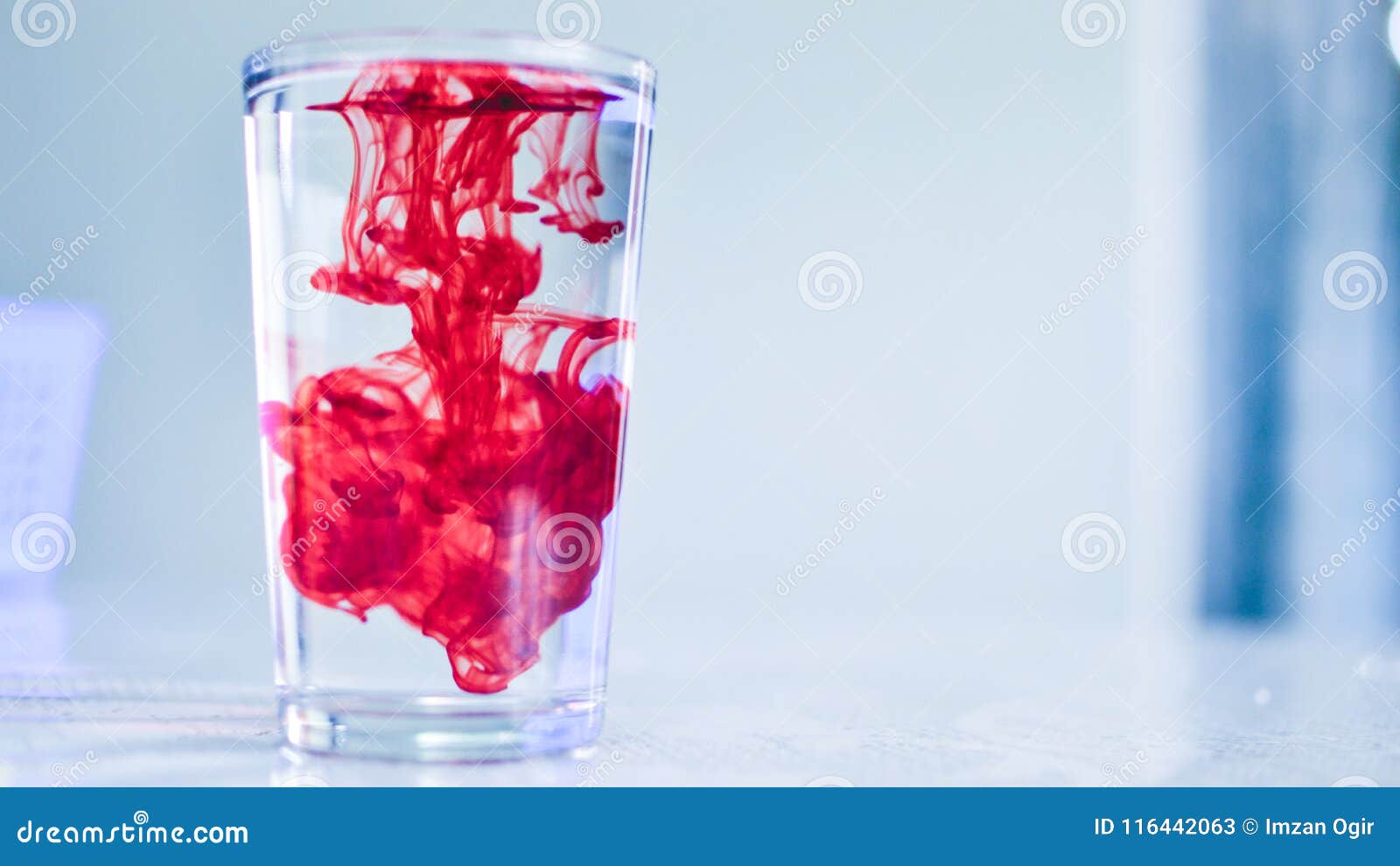 red dye in crystal clear water or refreshing drink