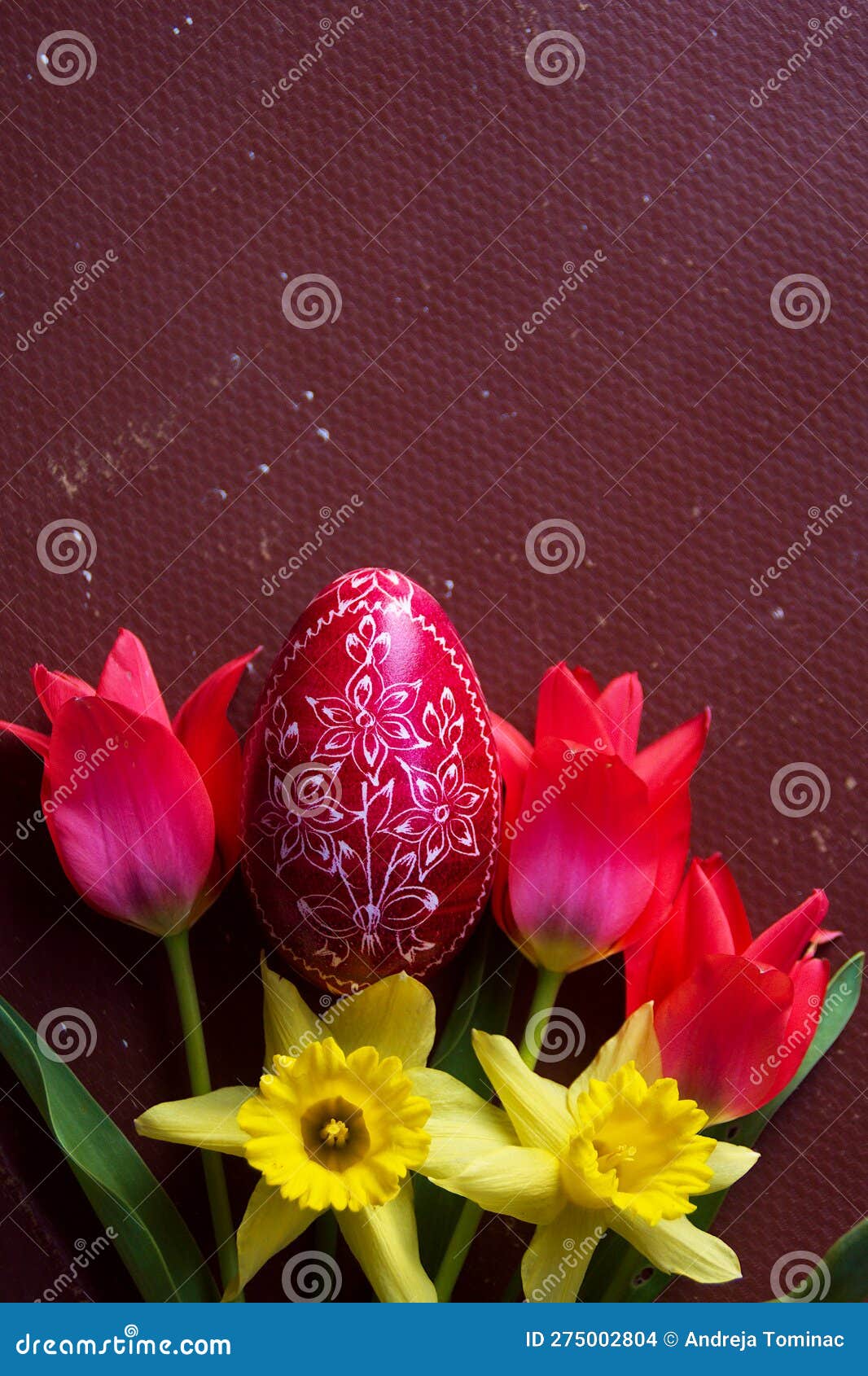 red easter egg, tulips and daffodills