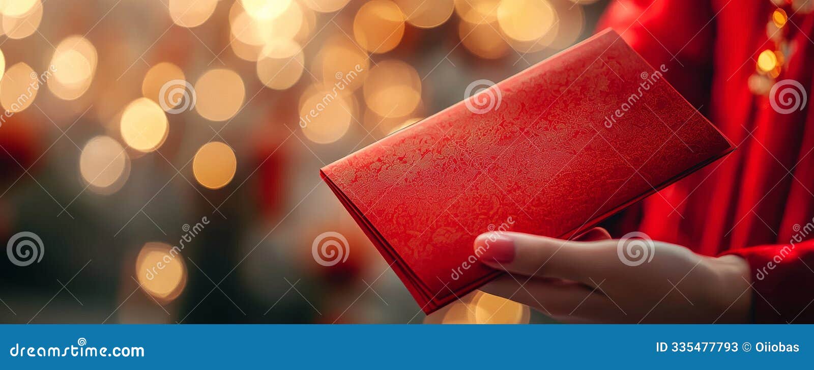 red envelope of fortune a close-up of a red envelope held in a hand against a festive background of golden bokeh lights