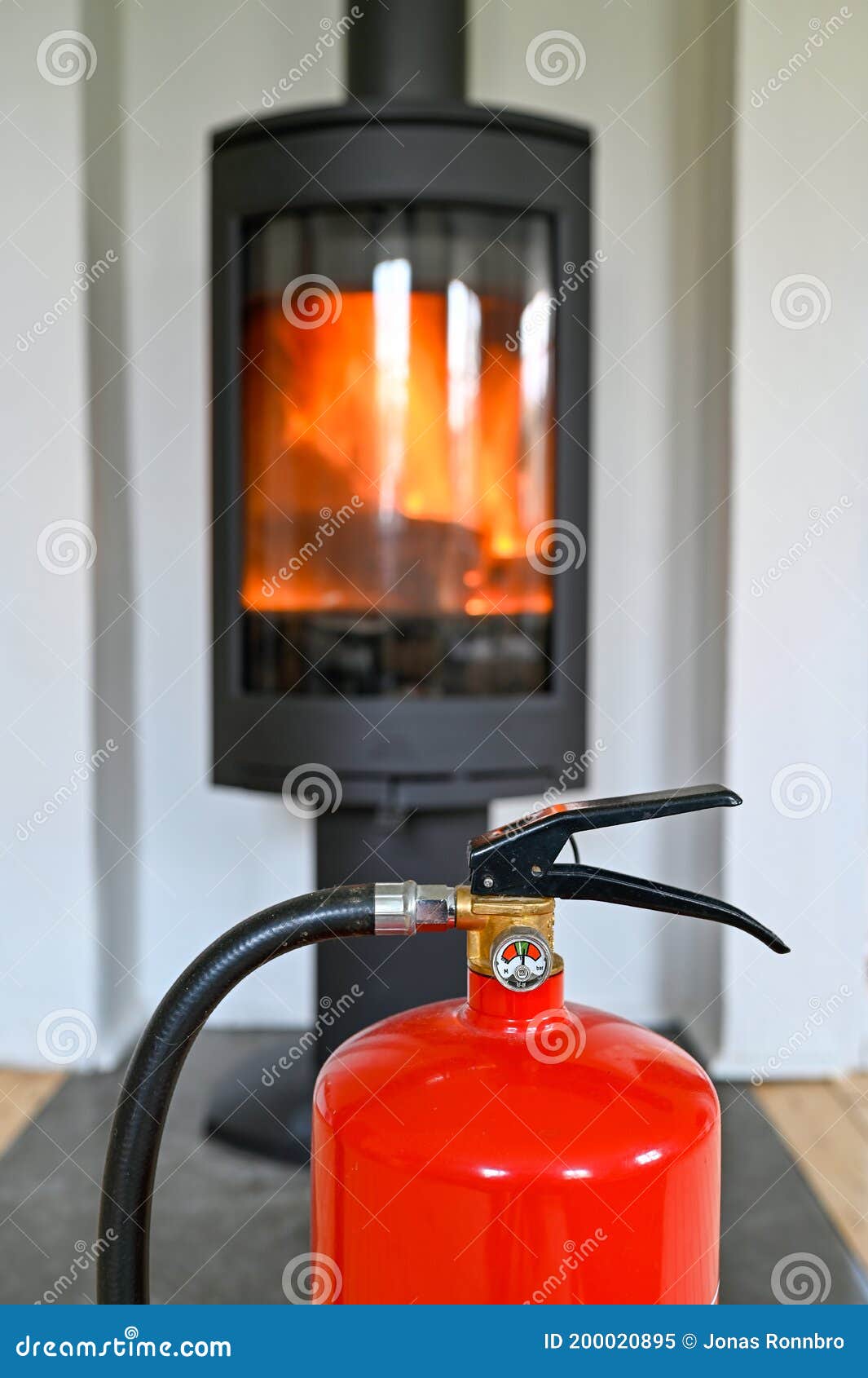 Red Fire Extinguisher Standing Infront of a Fireplace in Livingroom