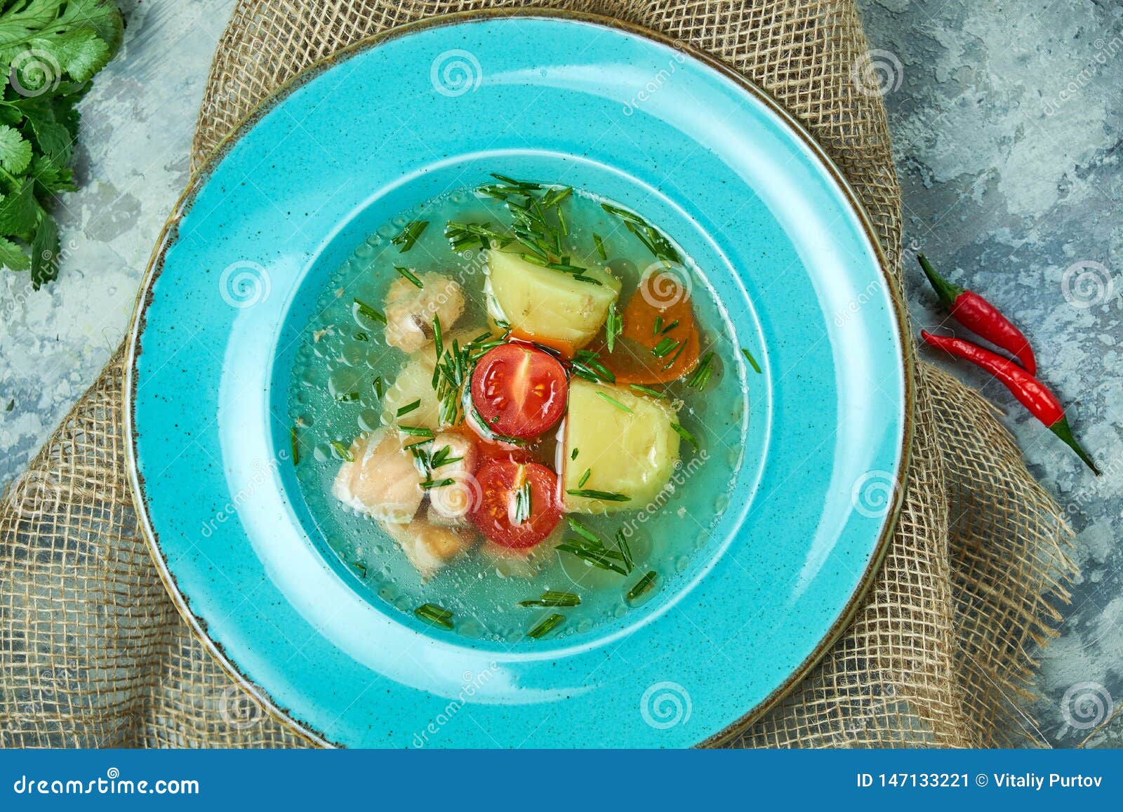 Red Fish Soup In A Blue Plate. Beautiful Serving Dishes