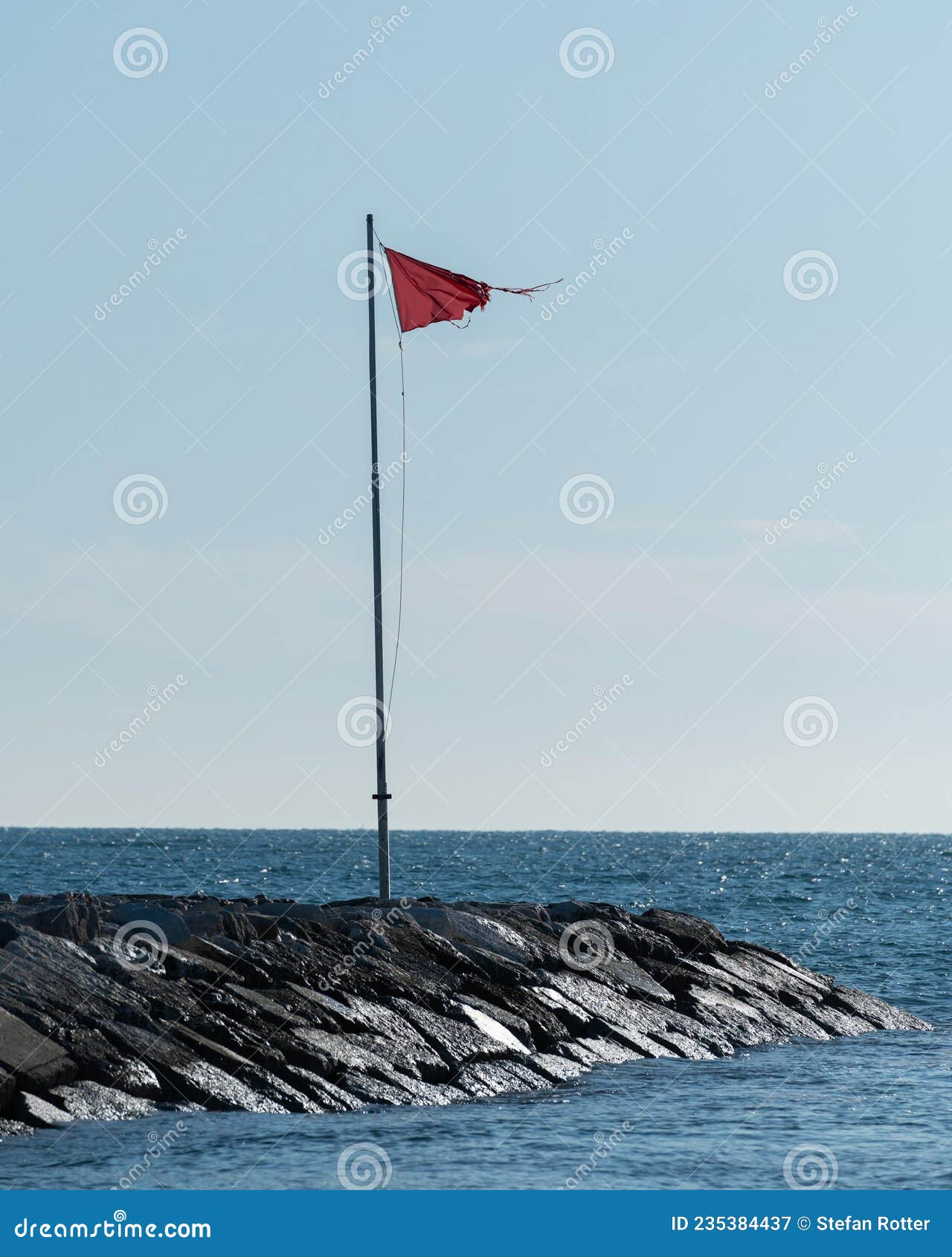 Red Flag on a Mast on the Beach Stock Image image image