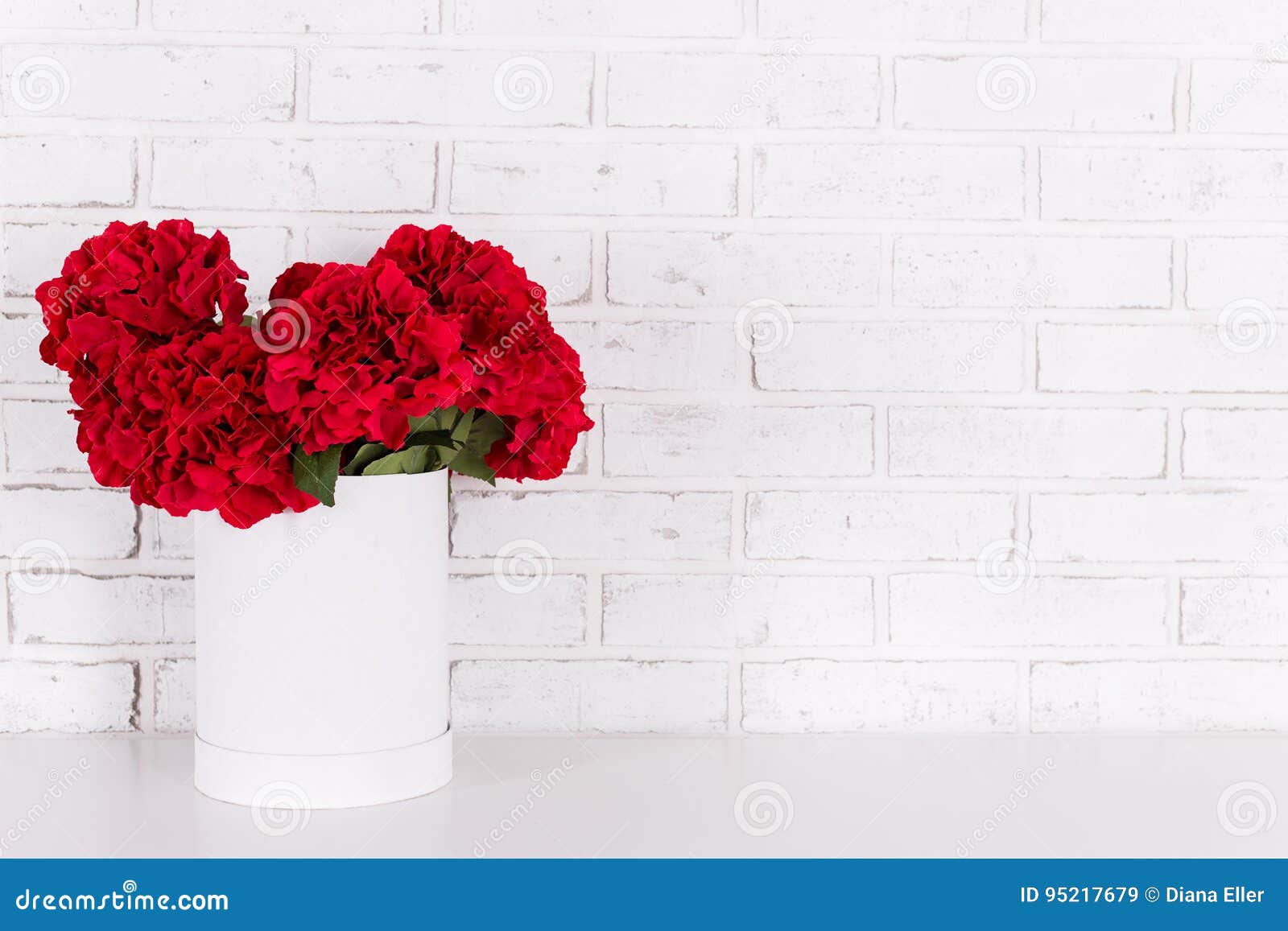 Red Flowers in Vase Over White Brick Wall Stock Image Image of bunch