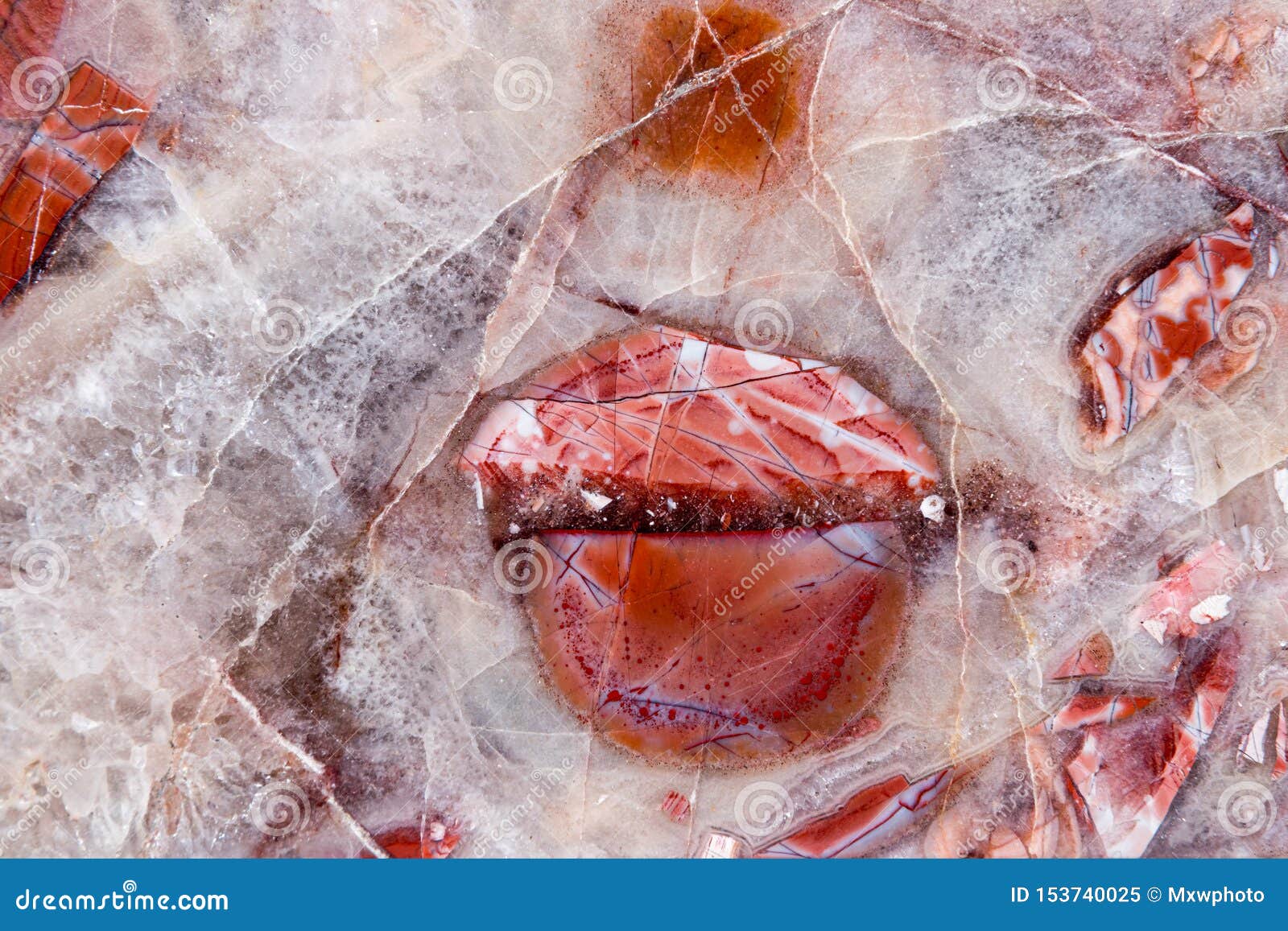 red gemstone with colorful structure in many tones texture