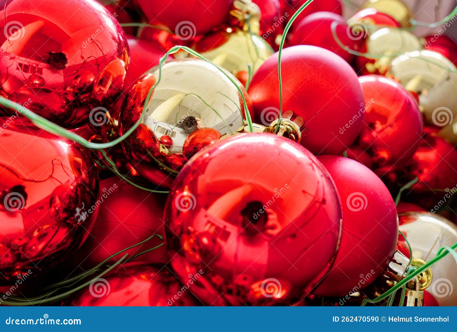 Red and Gold Christmas Tree Baubles with Hanging Wire. Stock Photo