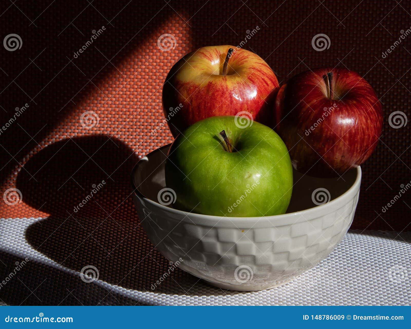 red and green apples in the sun