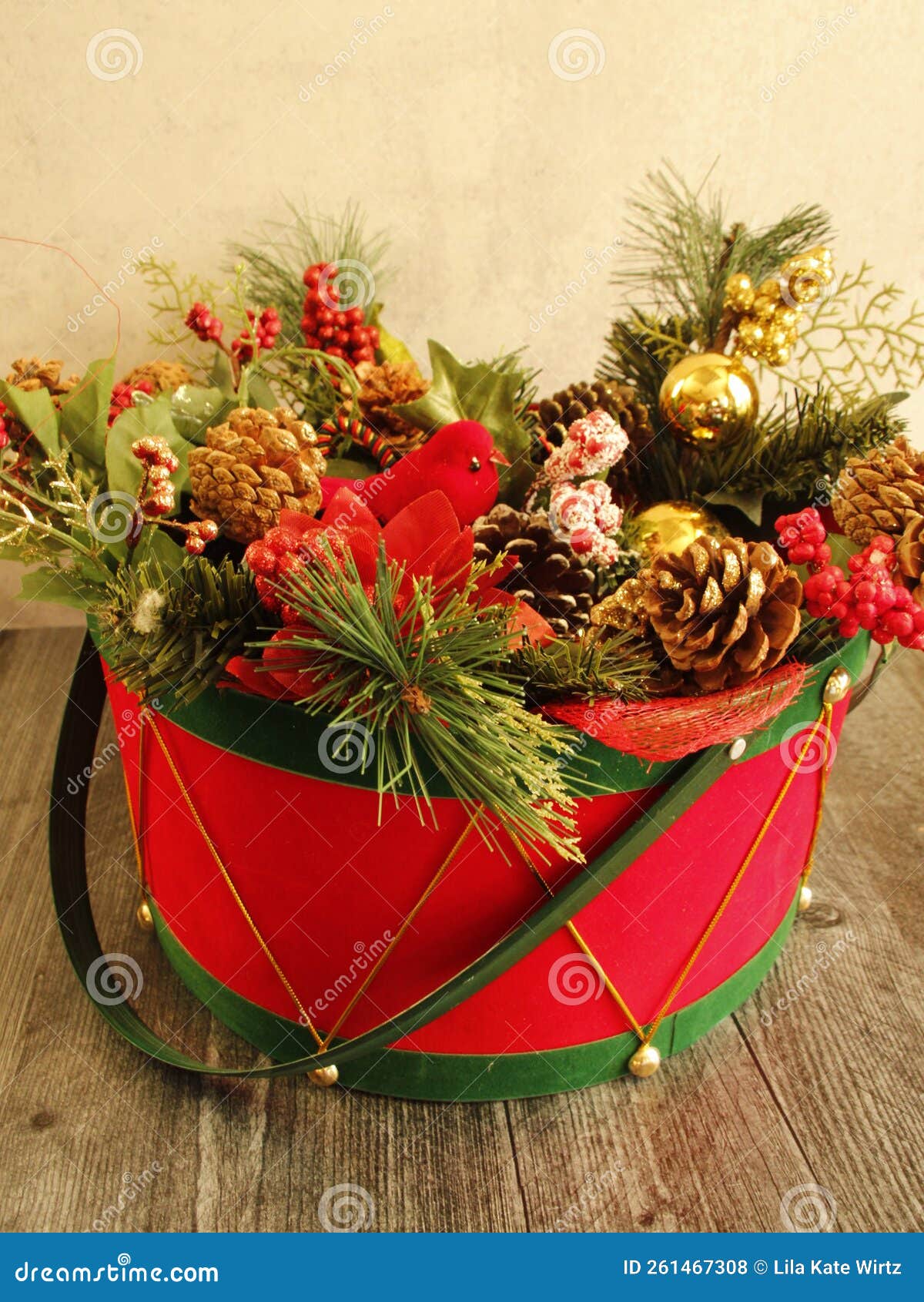 red and green christmas drum basket, evergreen branches, pine cones, berries, red cardinal bird,