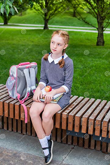 Red-haired Girl Sits on a Bench and is Sad. Pupil, Student in School ...