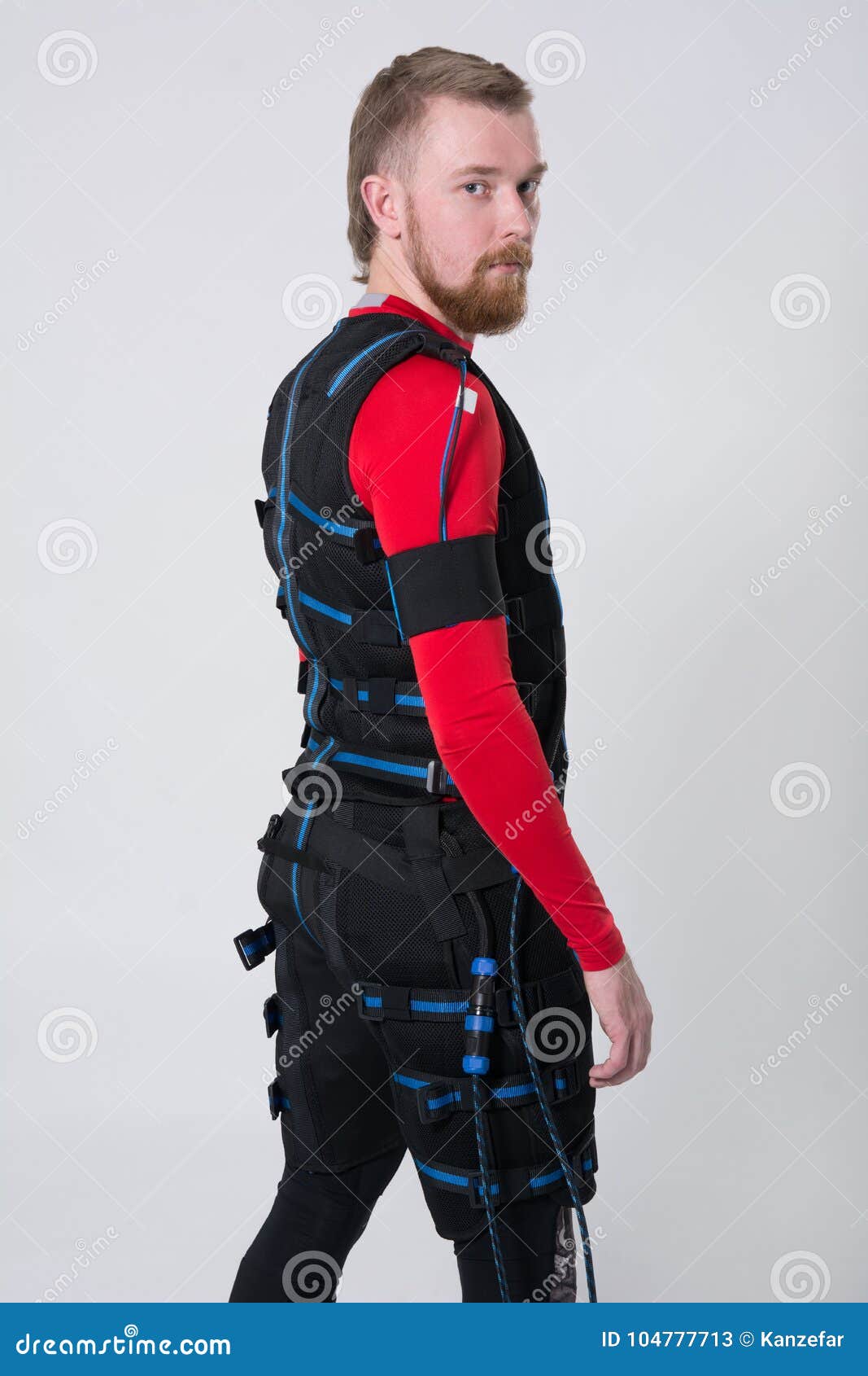 red-haired man with a beard in electric muscular suit for stimulation