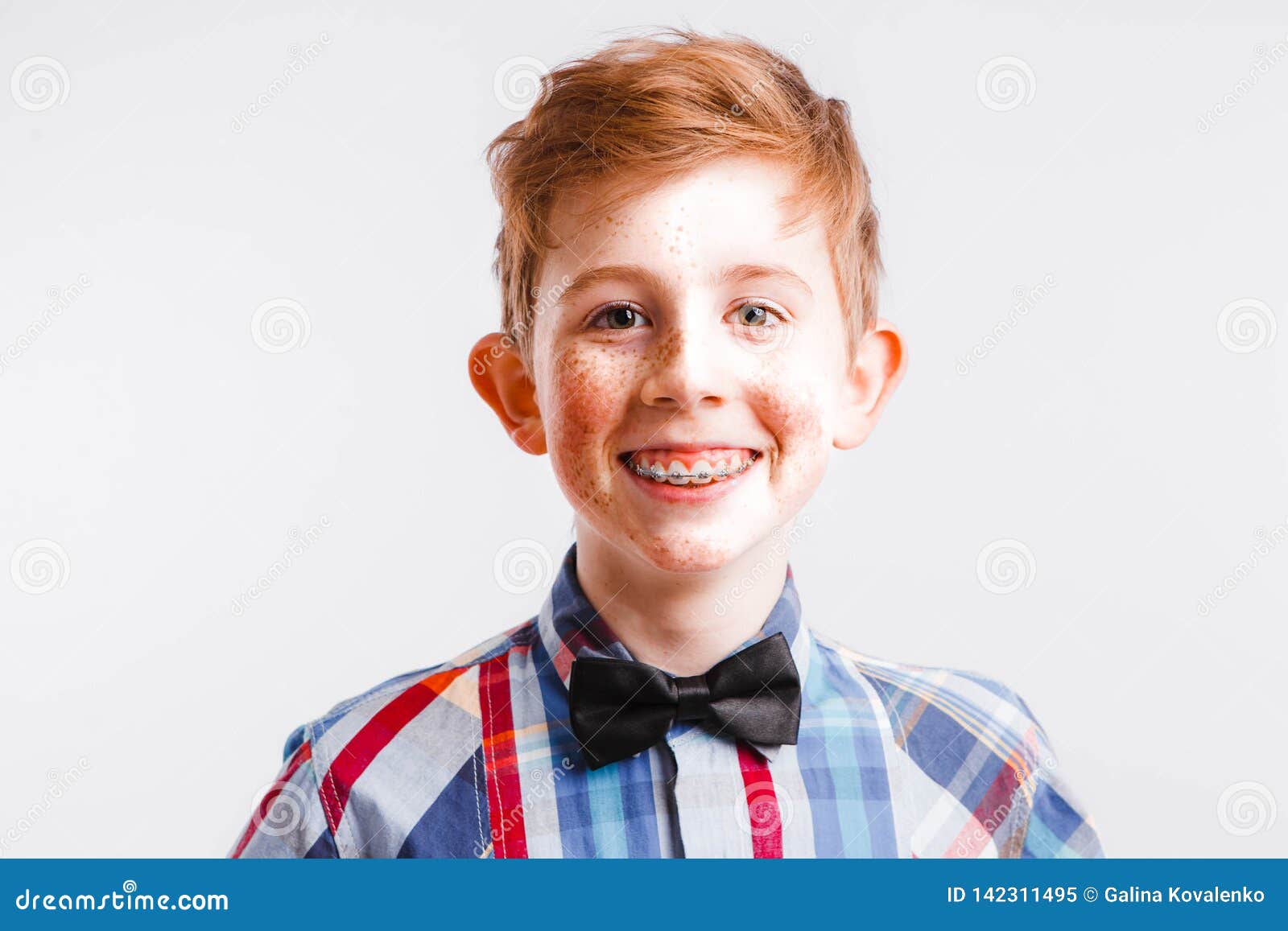 Red Haired Nerd With Braces And Glasses On A White Background Stock