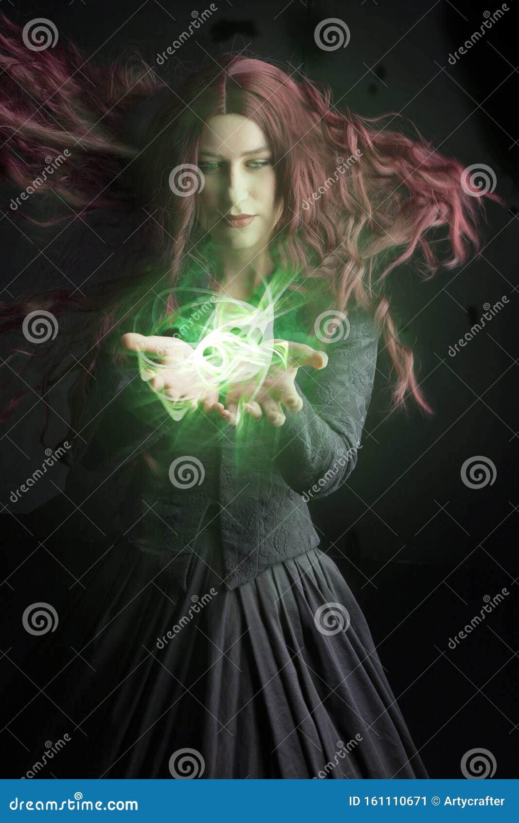 red-haired woman in a black victorian ensemble and a witch-like pose. an orb of light is in her hand.