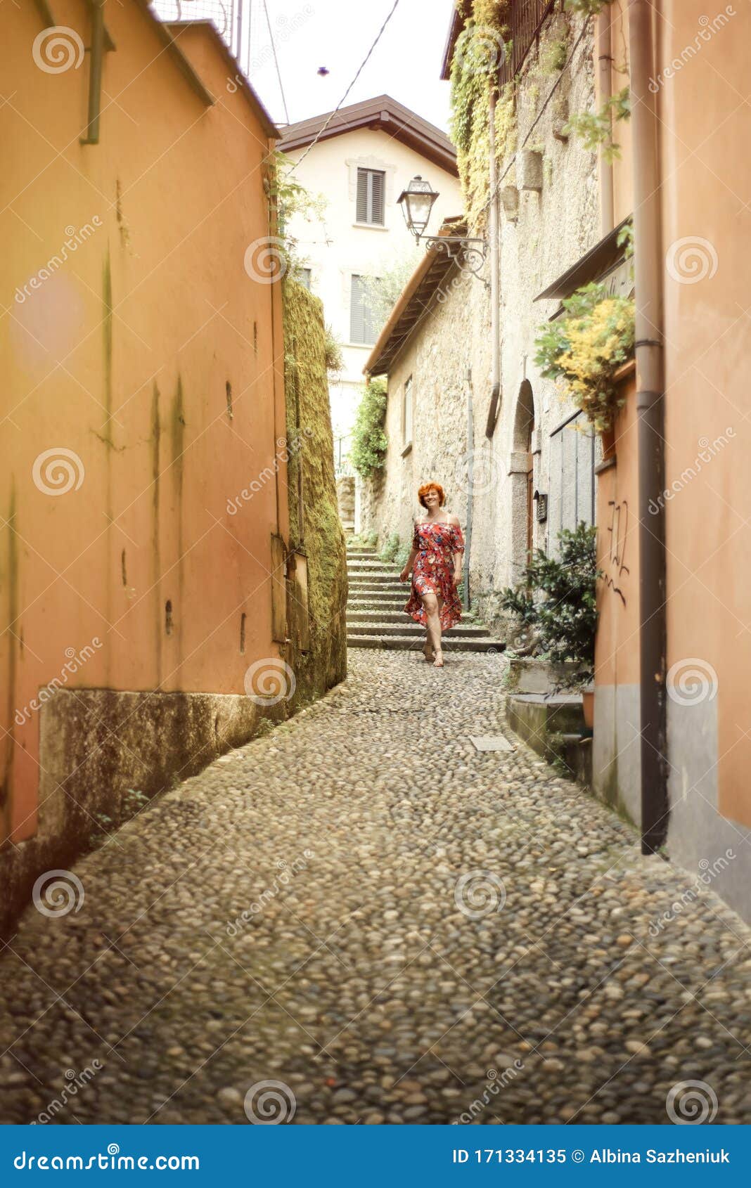 Red Haired Woman in Red Dress Walking on Stone Street in Italian Small ...