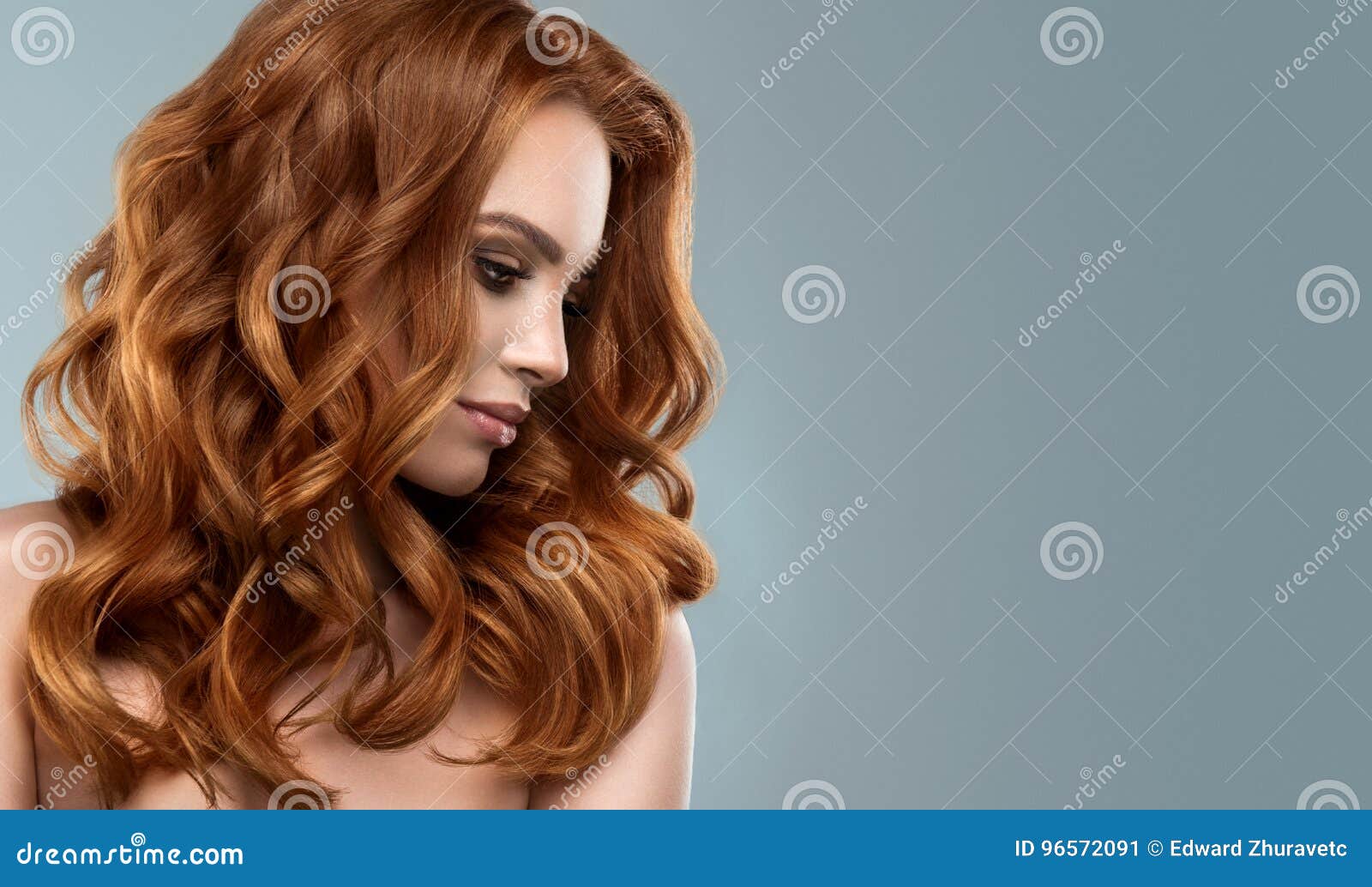 red haired woman with voluminous, shiny and curly hairstyle.frizzy hair.
