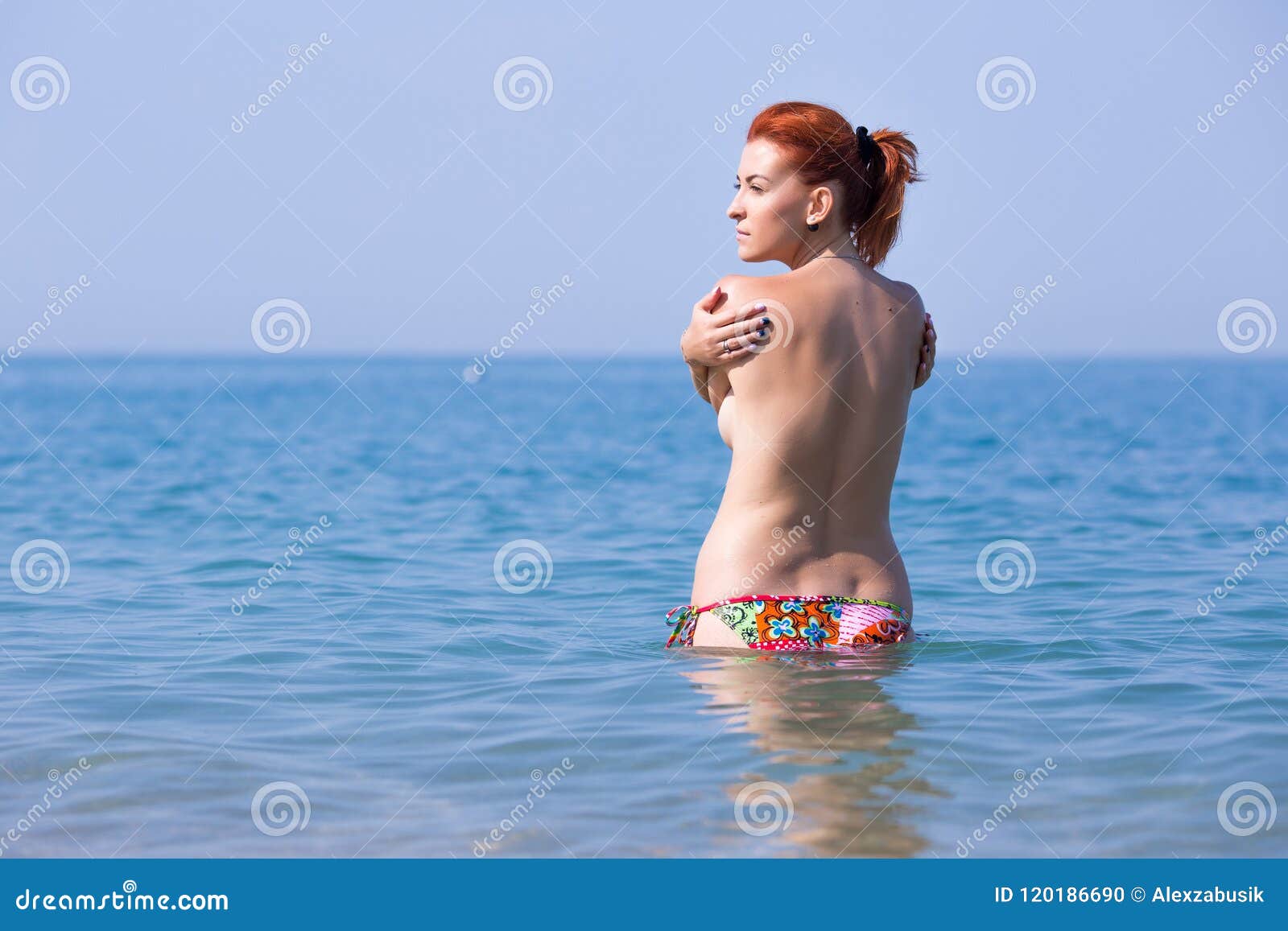Cute naked red haired teen swimming