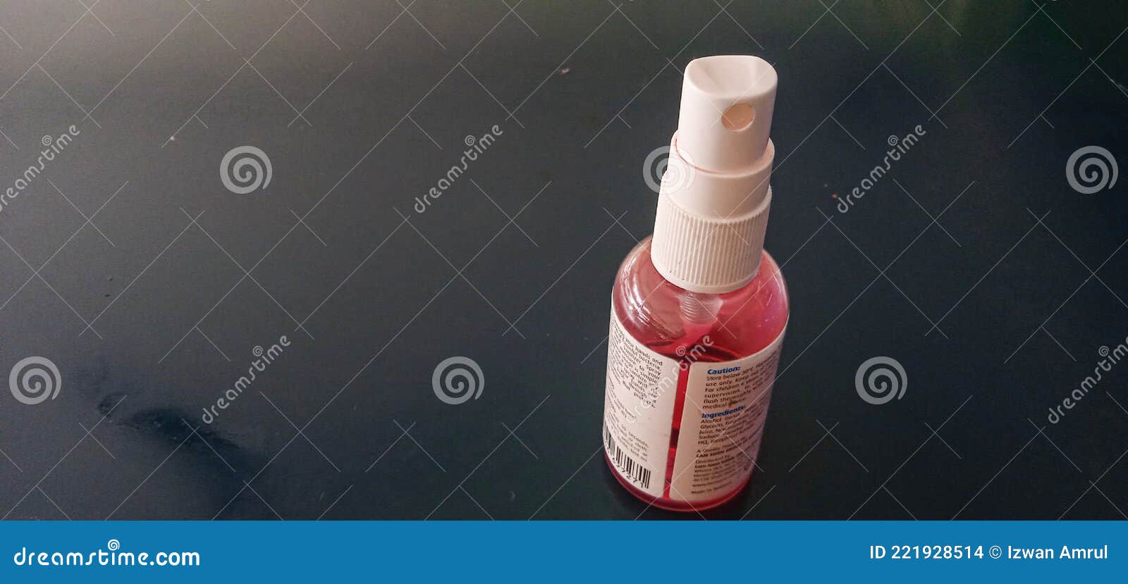 The Red Hand Sanitizer in the Bottle is on the Table and Ready To Use