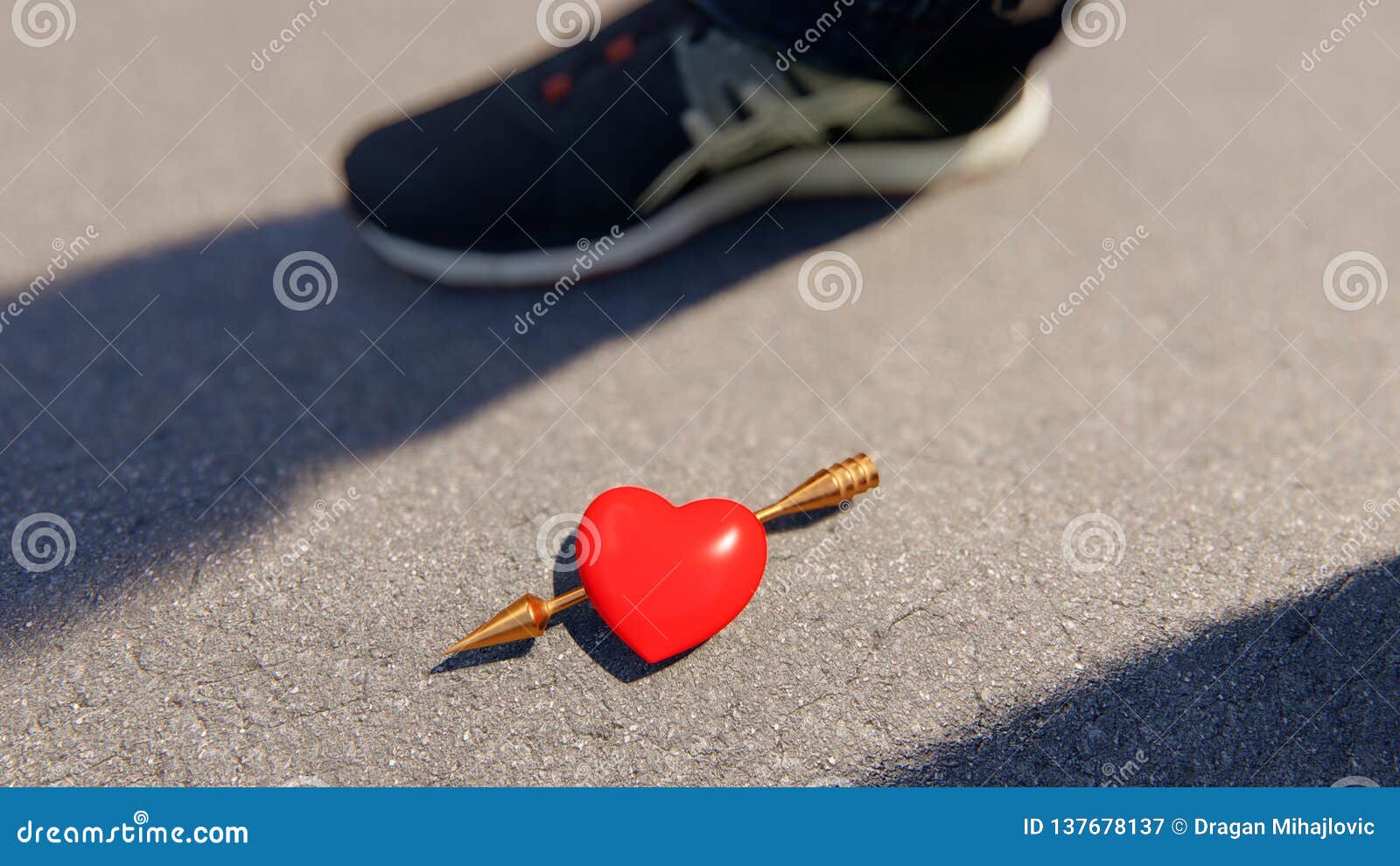 red heart with amor arrow on the asphalt, bokeh