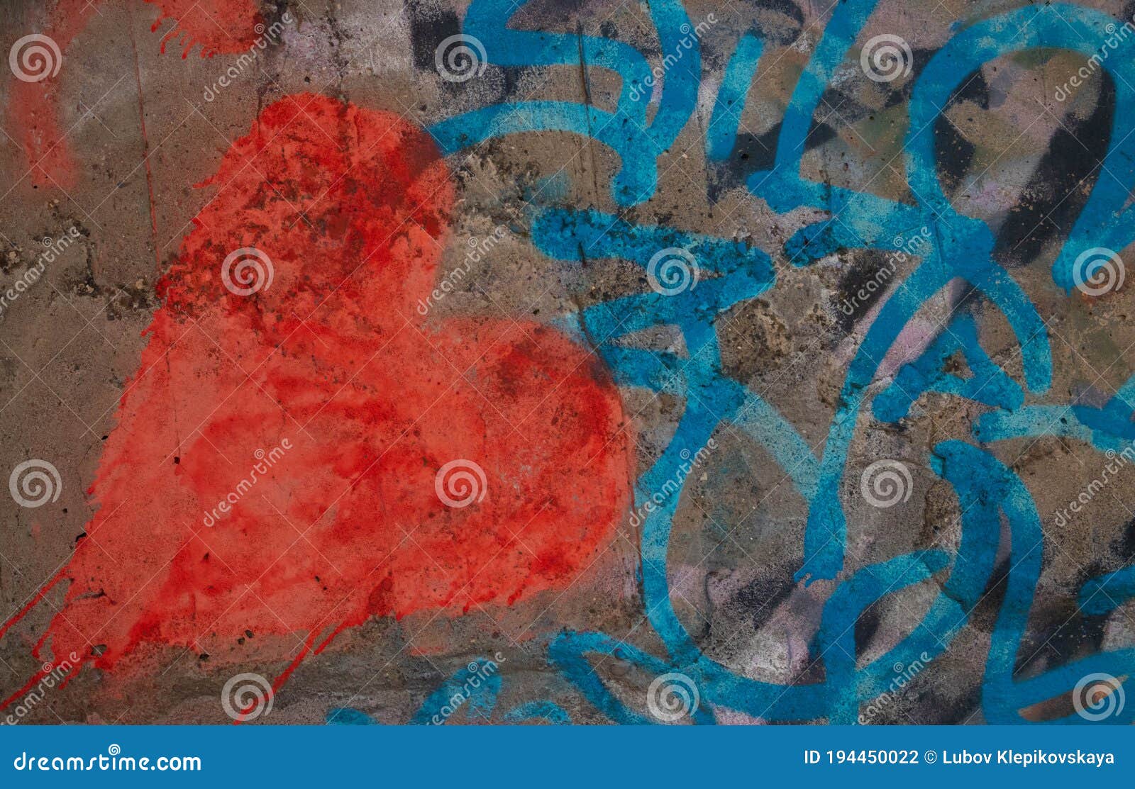 a red heart on a gray concrete wall