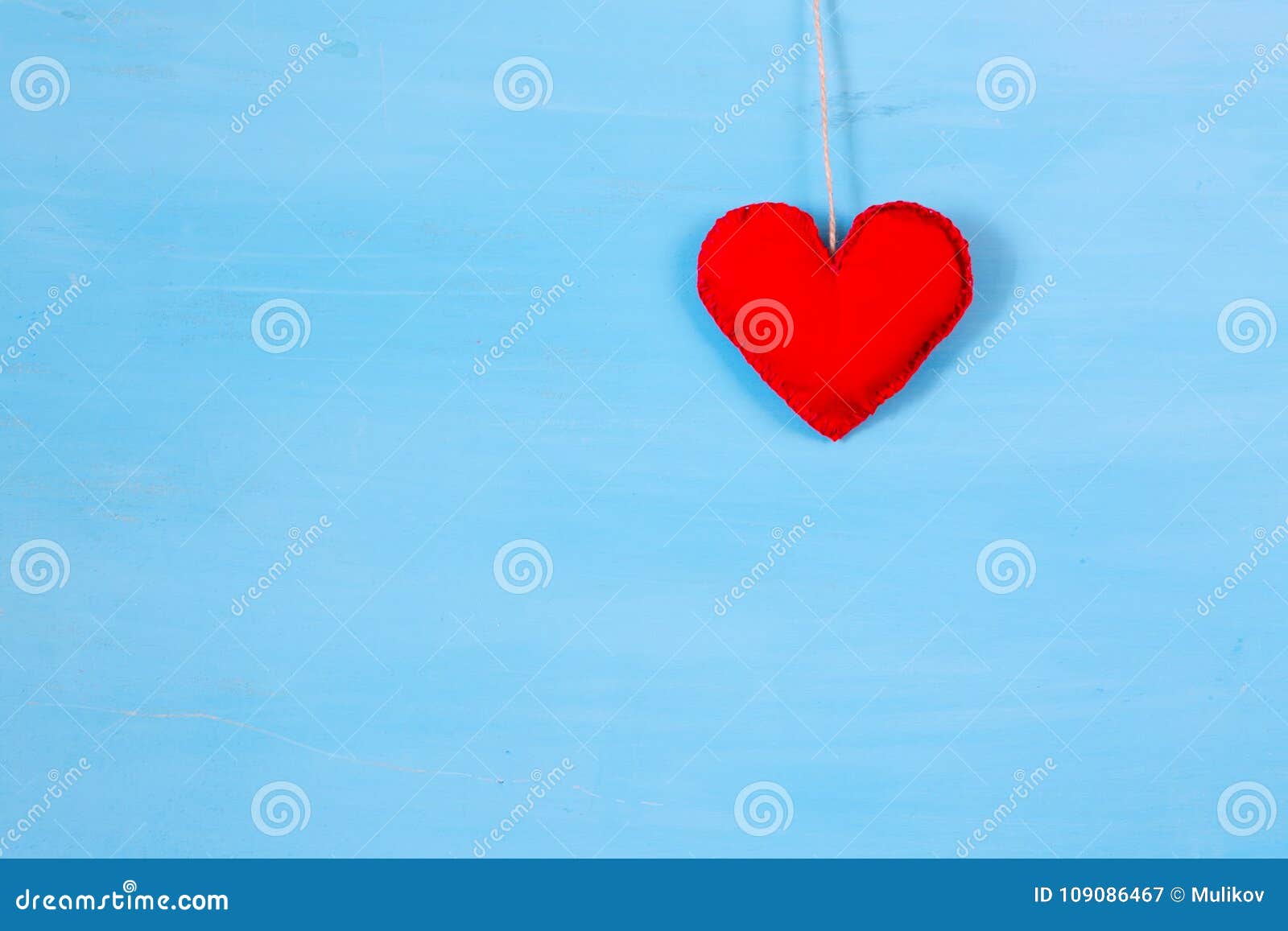 red heart on string. romantic love vintage wooden background