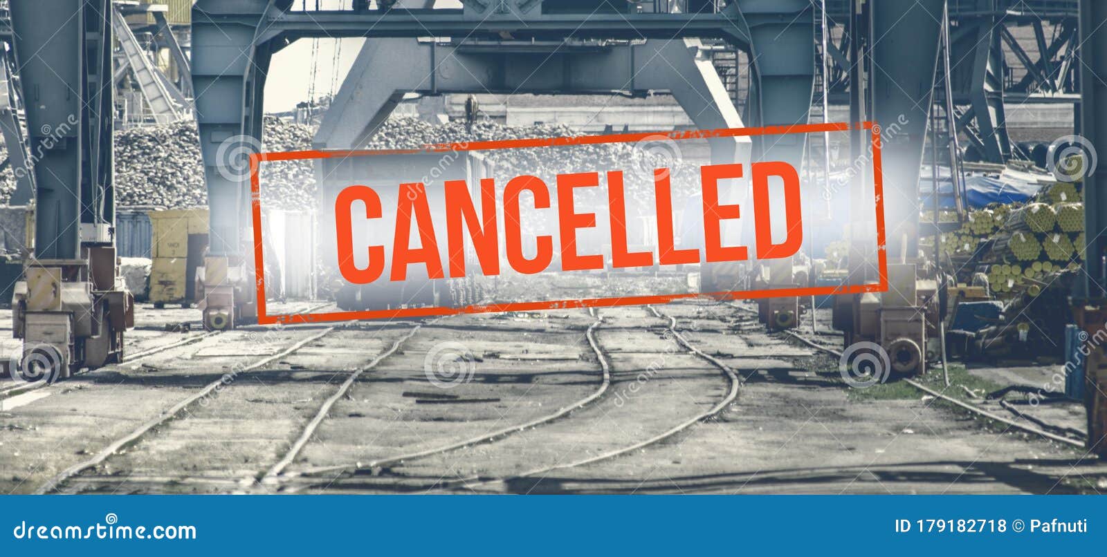 red inscription cancelled on a blurred background of railway wagons and cranes on production