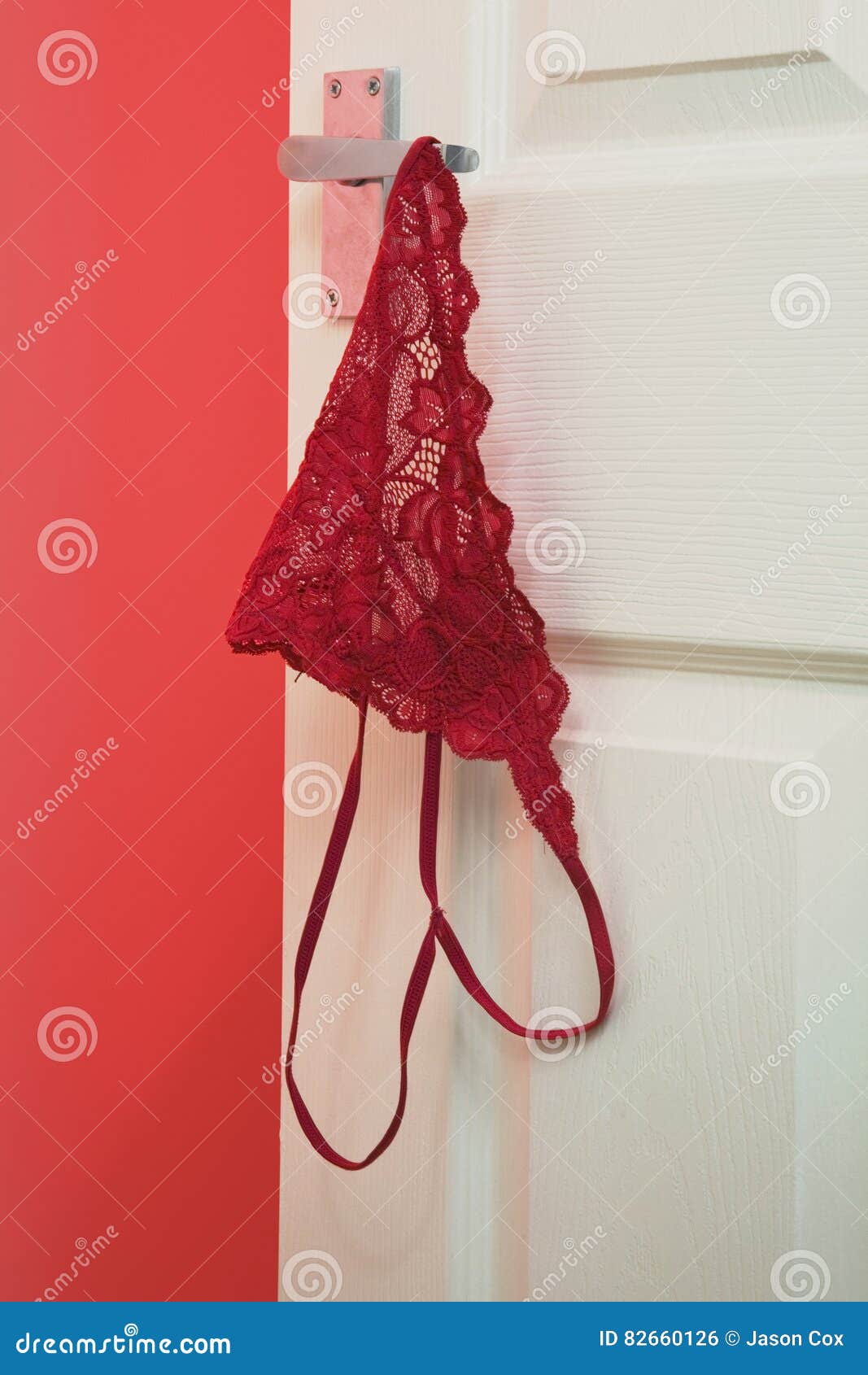 Red Knickers Hanging Off a Bedroom Door Handle Stock Photo - Image