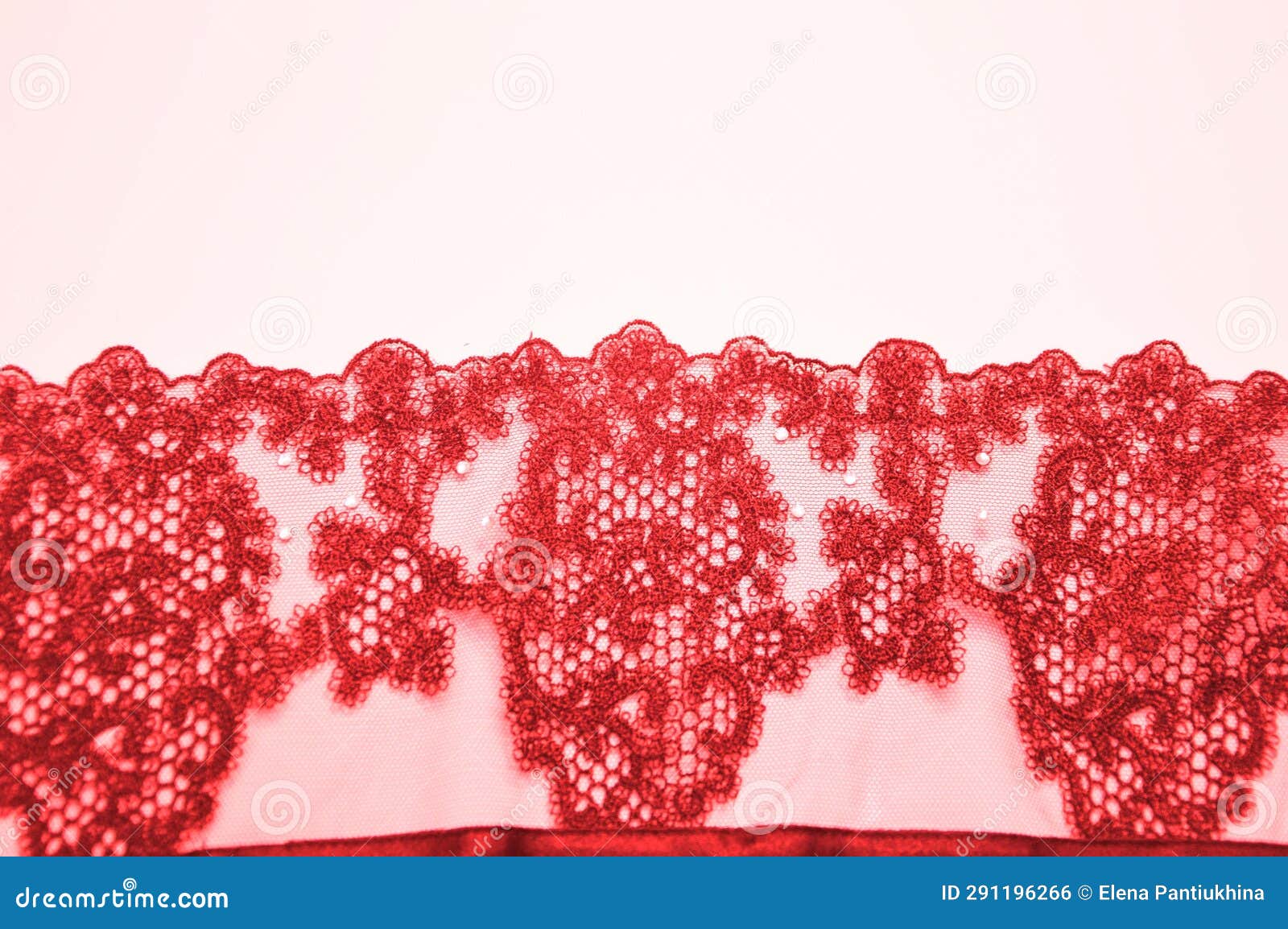 red lace with a beautiful openwork pattern on a white background. finishing  for lingerie, clothing