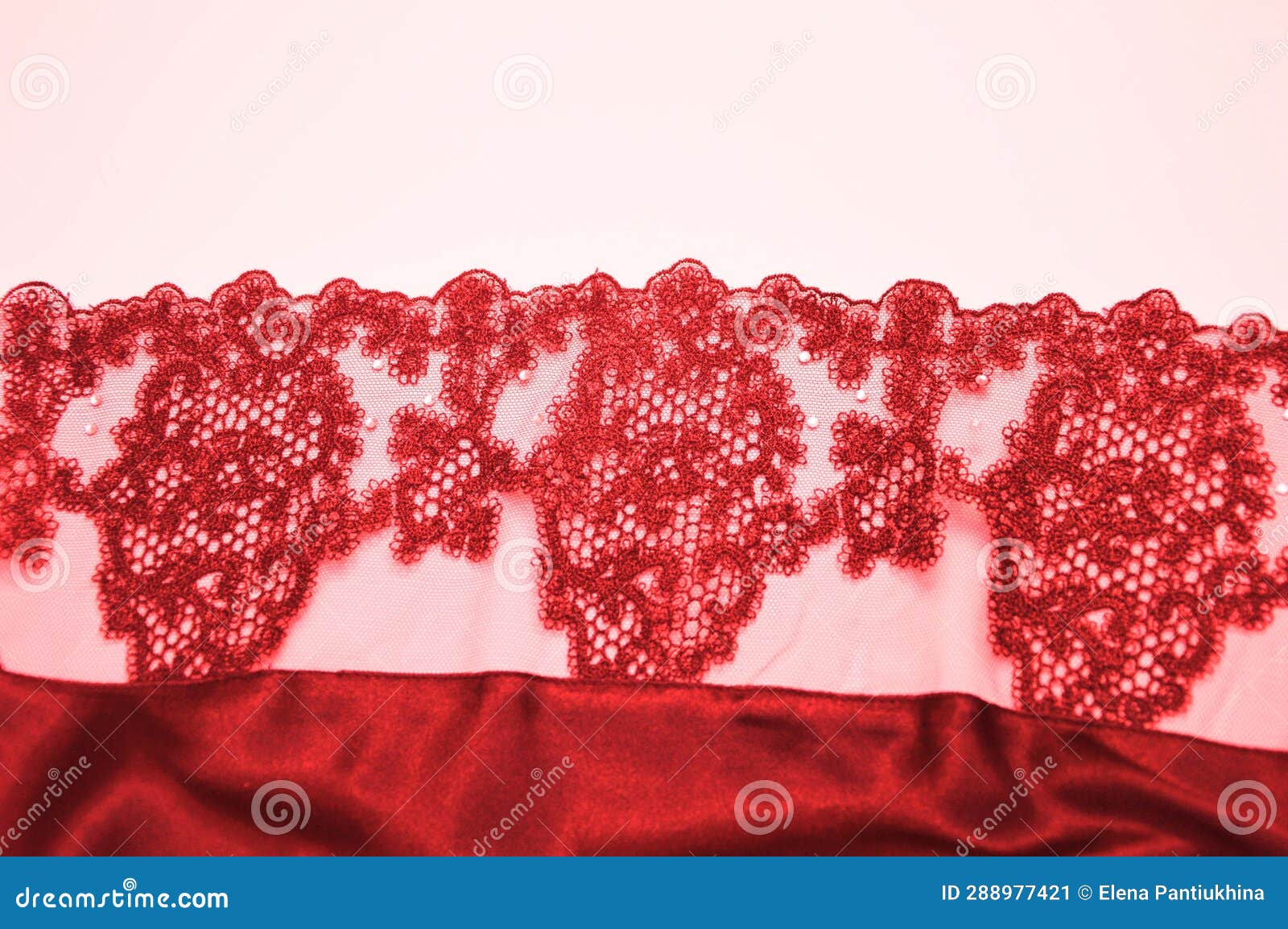 red lace with an openwork pattern on a white background. finishing  of lingerie, negligee