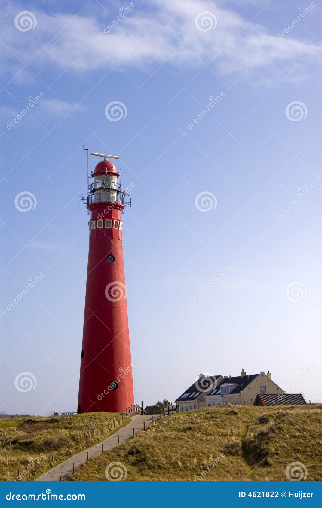 red lighthouse in dunes at schiermonnikoog