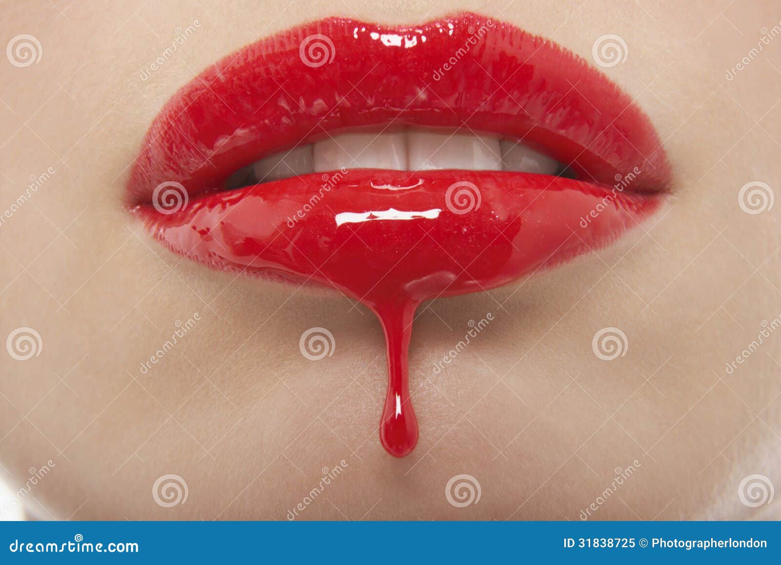red lipgloss dripping from woman's lips