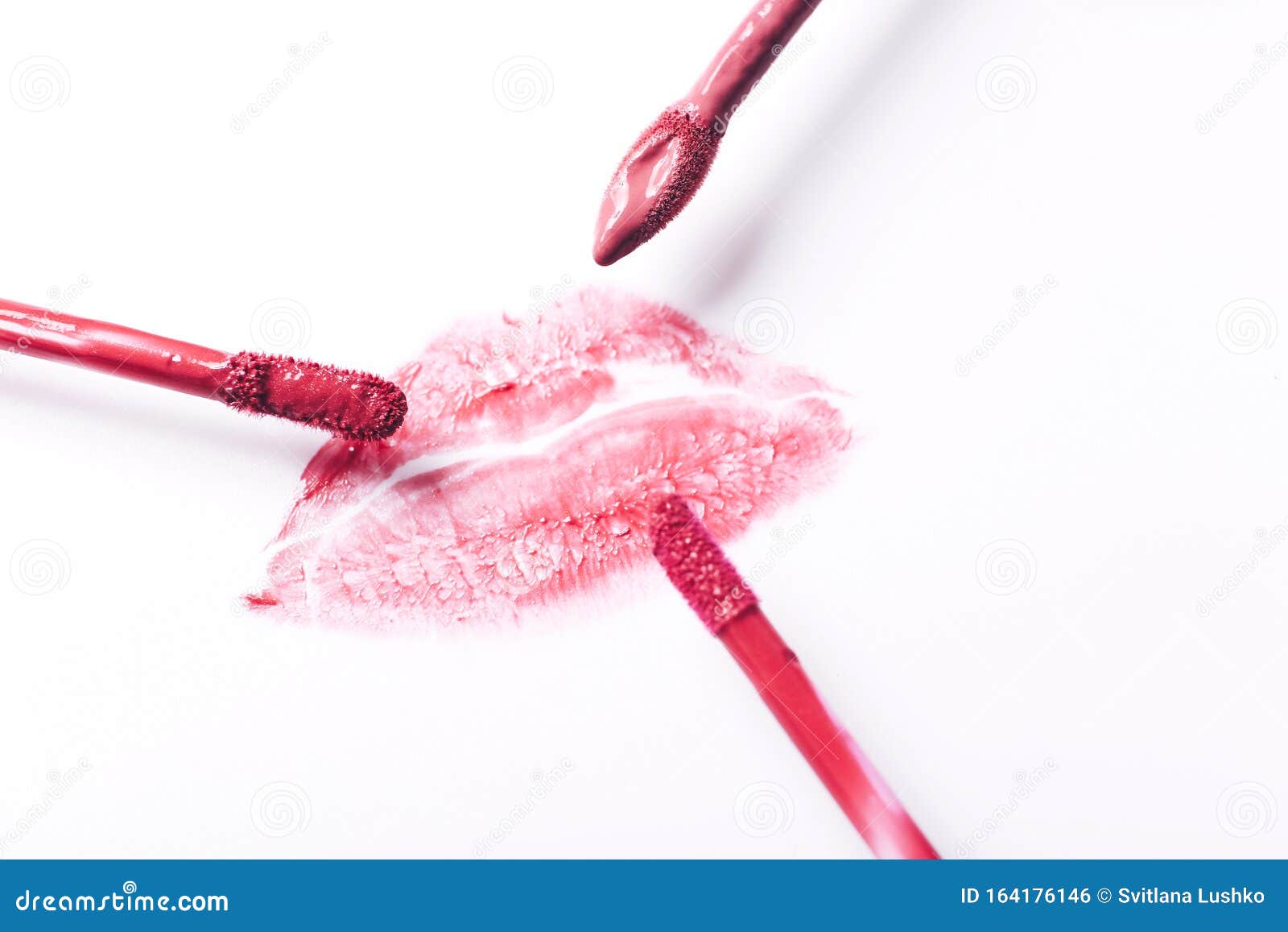 Red Lipstick Kiss with Lipstick Brushes on White Background Stock Photo