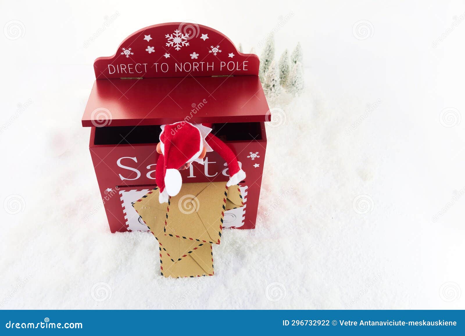 red mailbox for christmas mailings with letters to santa claus and elf.