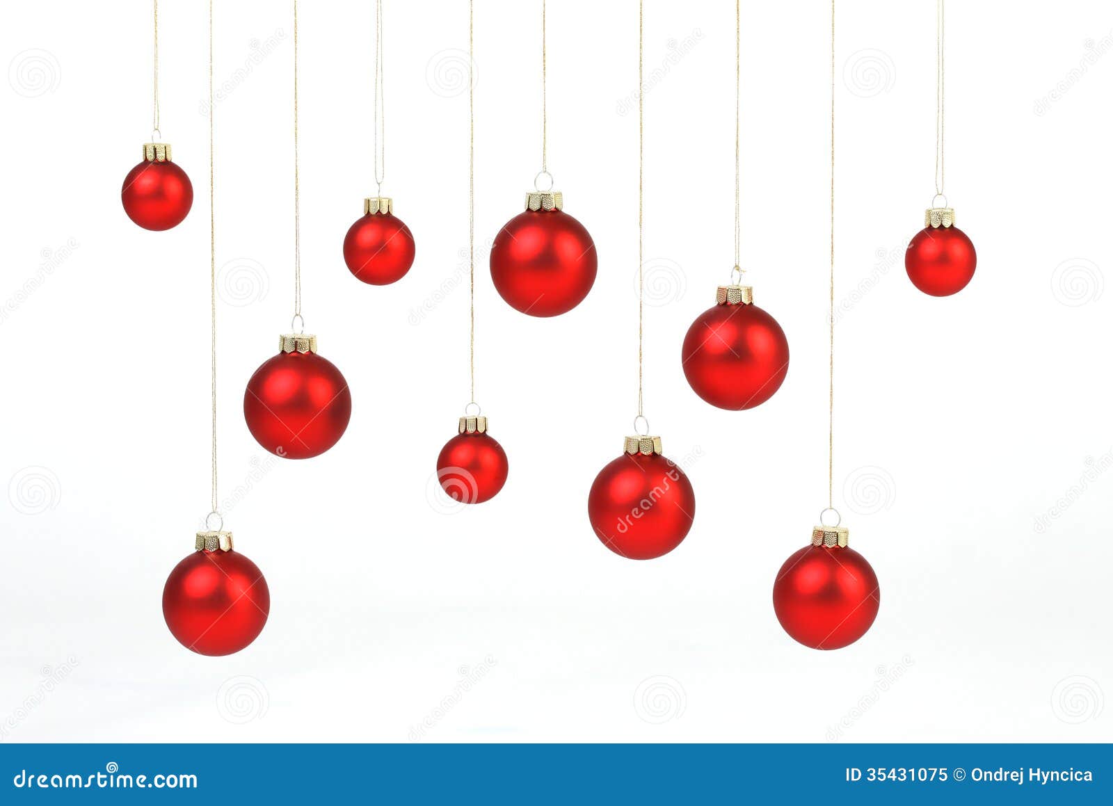 red matt christmas balls hanging on golden strings on white background